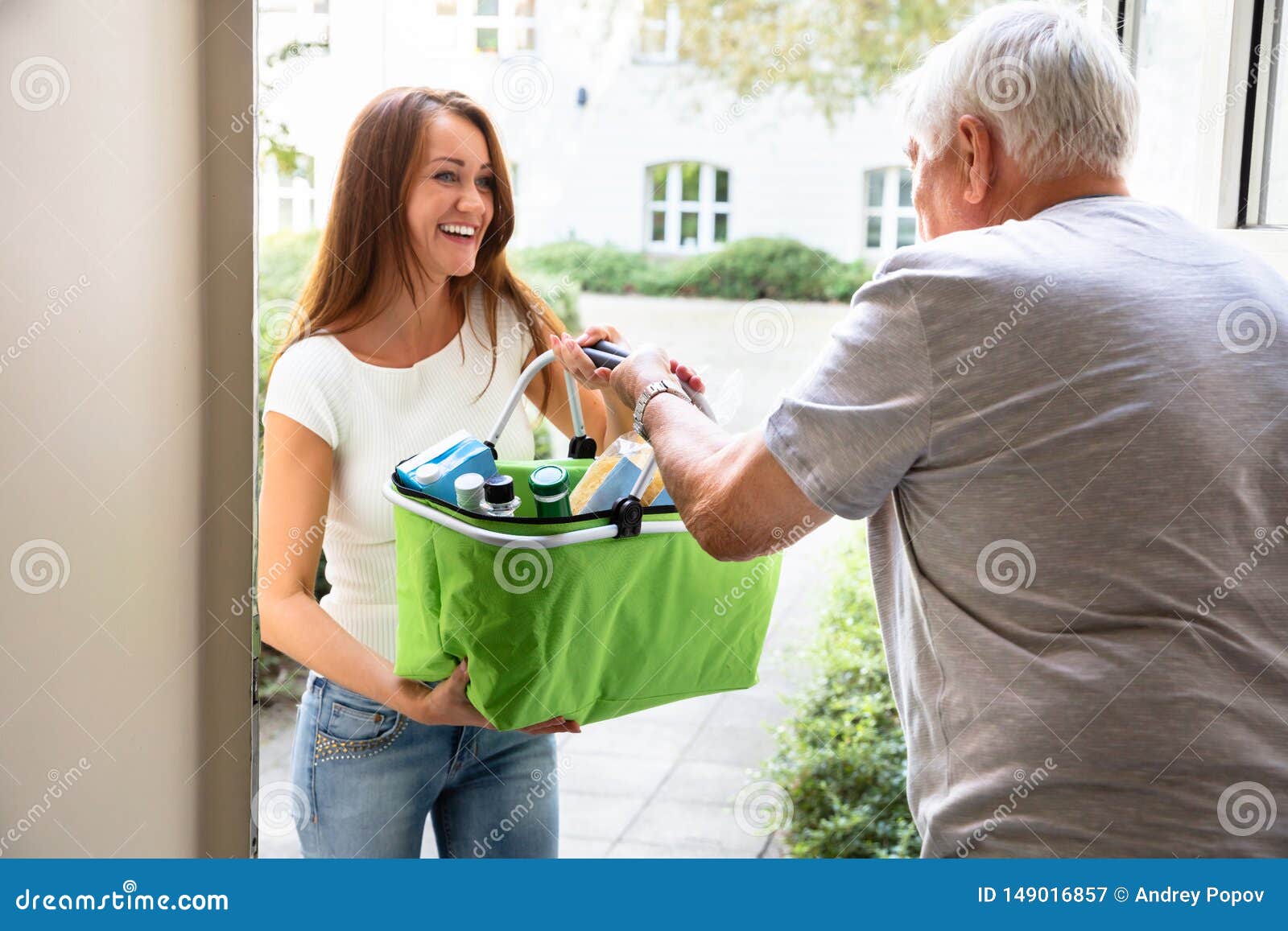 man offering help to his daughter carrying groceries