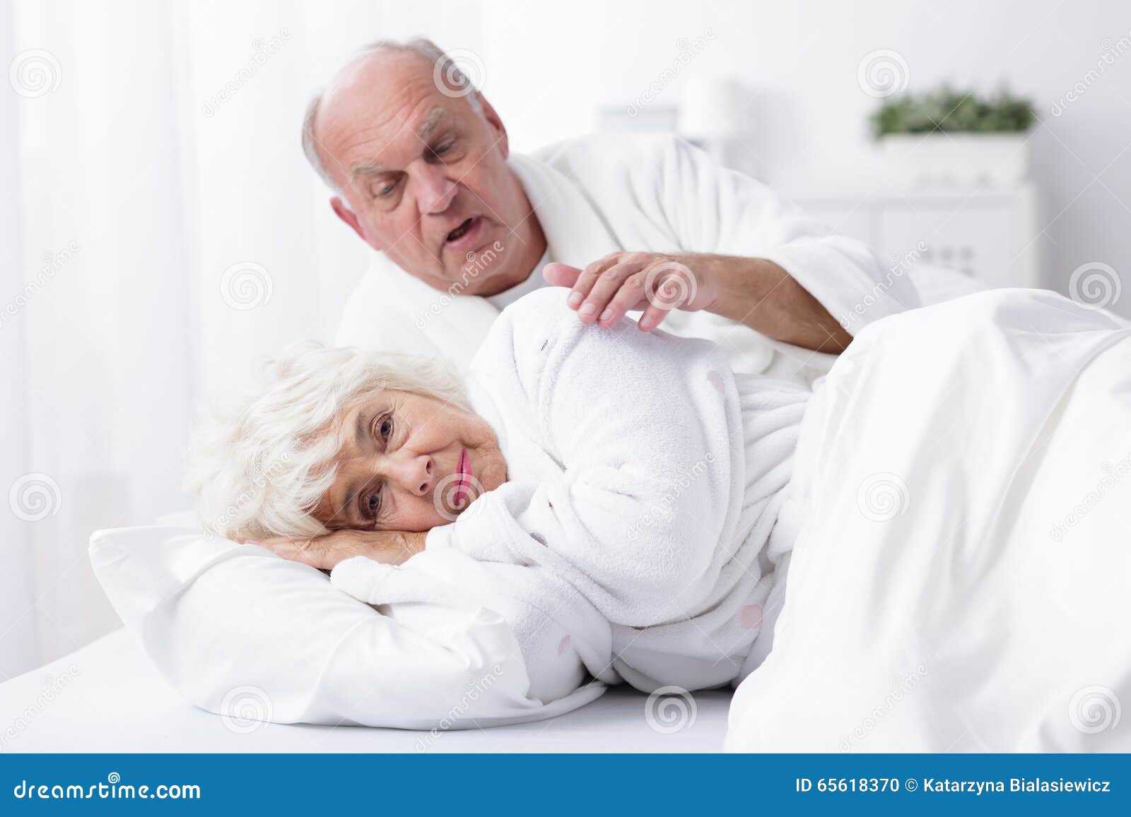 Senior marriage in bed stock photo
