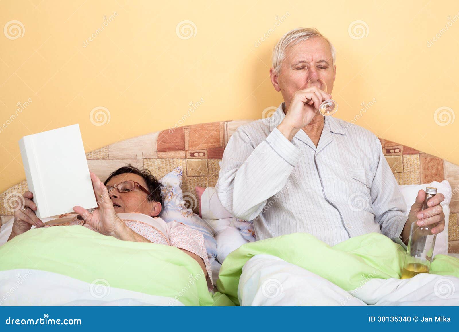 Seniors Relax with Alcohol in Bed Stock Photo Image of book, liquor