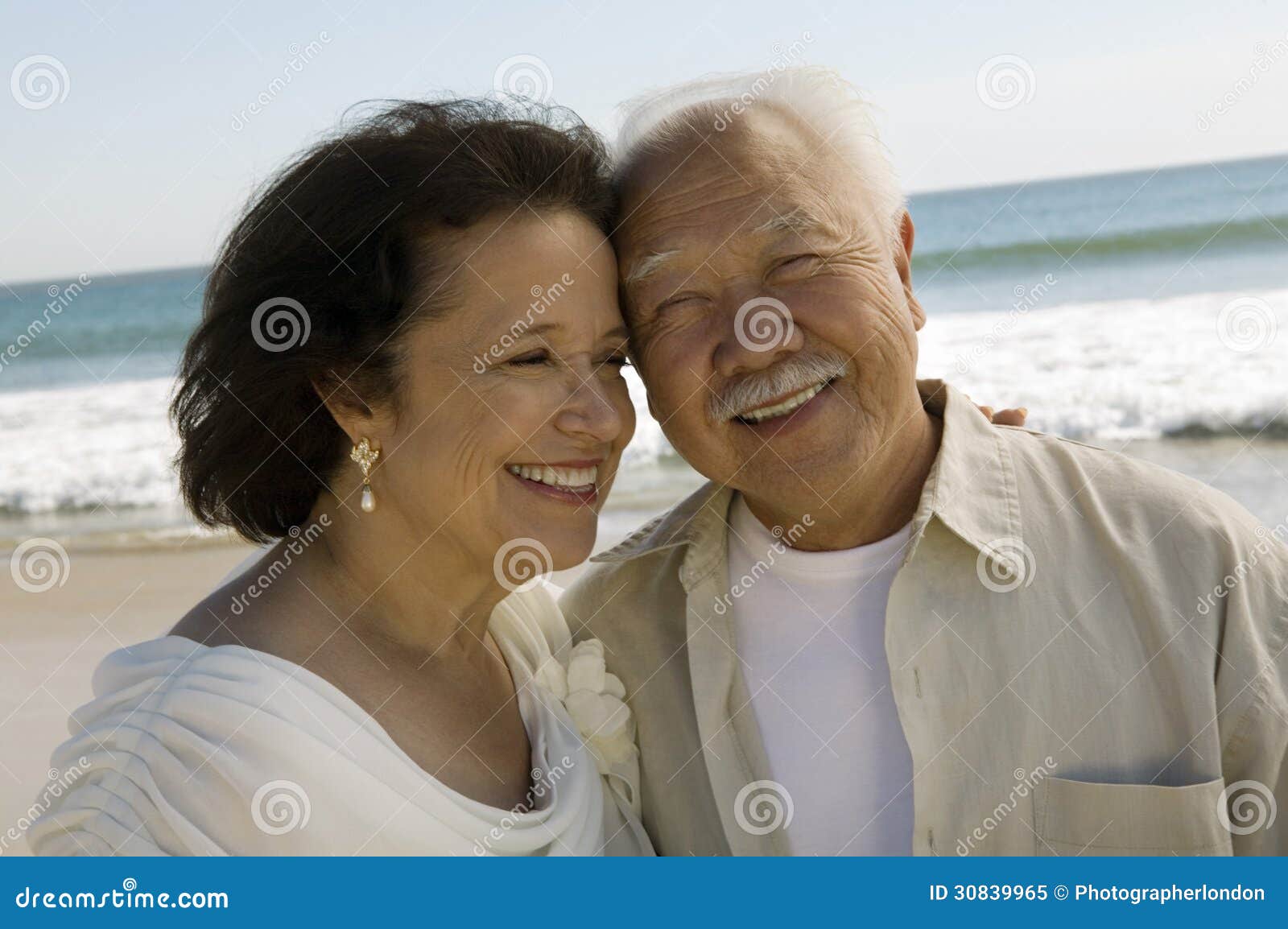 senior newly wed couple at beach (close-up)
