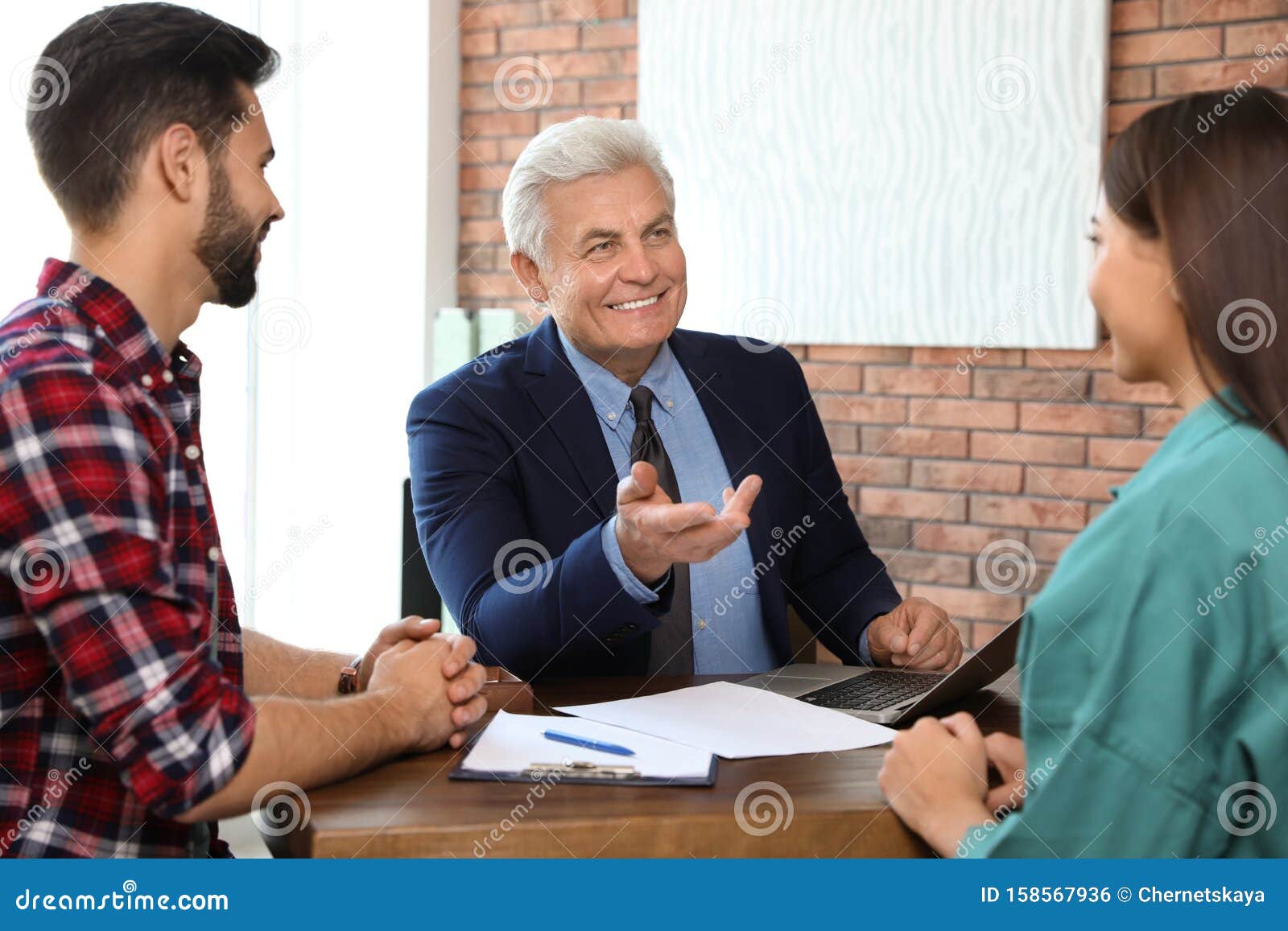 Senior Notary Working with Young Couple Stock Photo Image of help