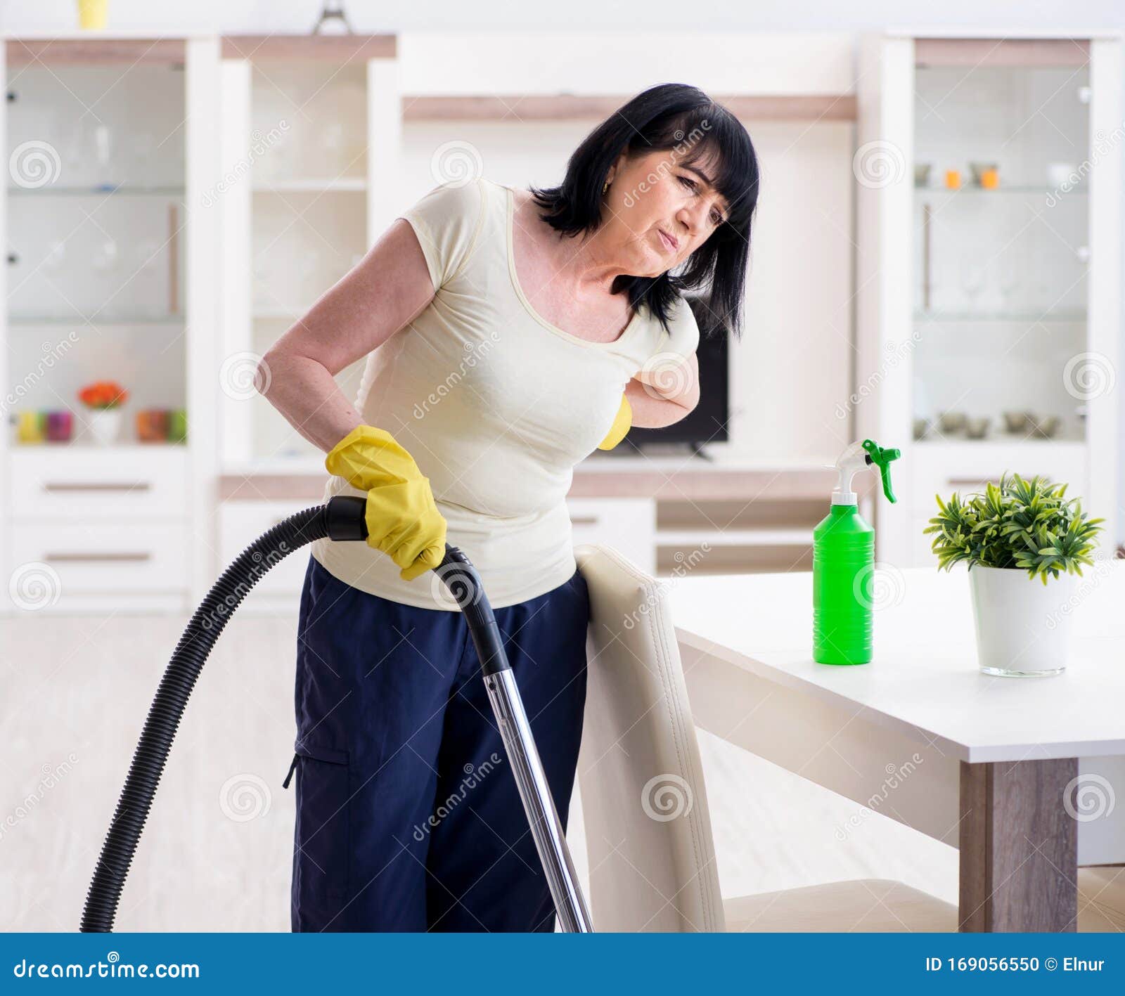 Senior Old Woman Tired After Vacuum Cleaning House Stoc