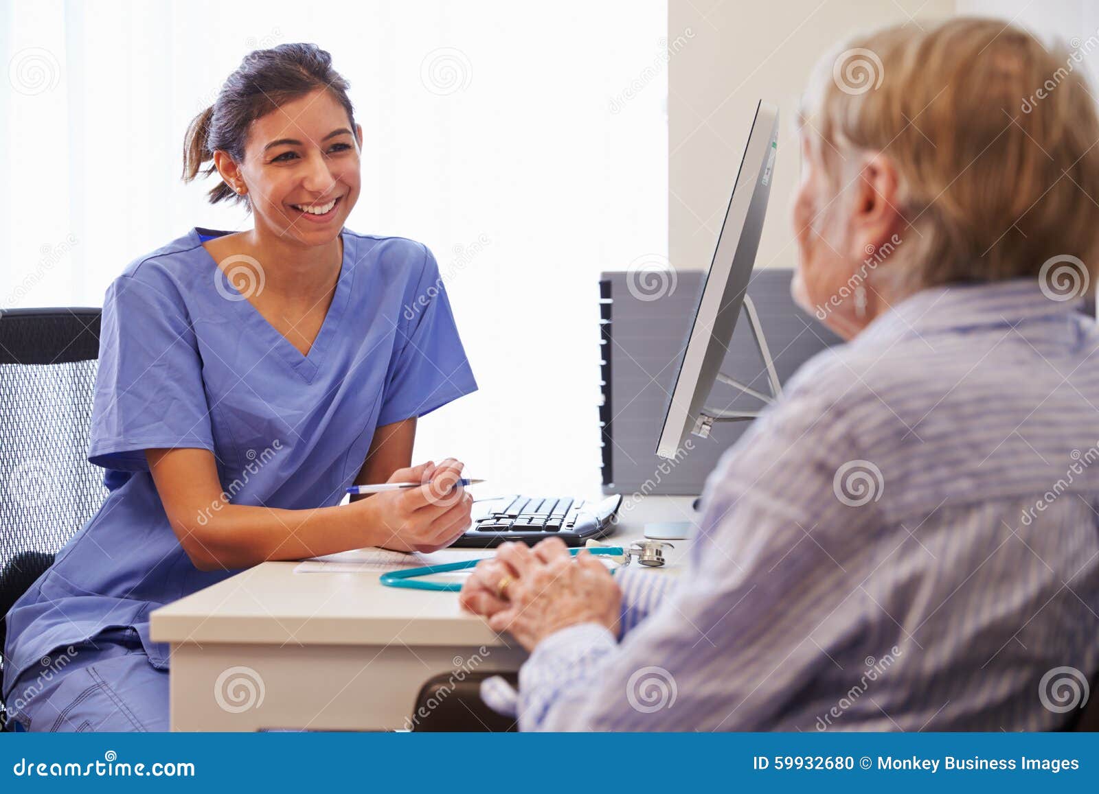 Senior Patient Having Consultation with Nurse in Office Stock Photo