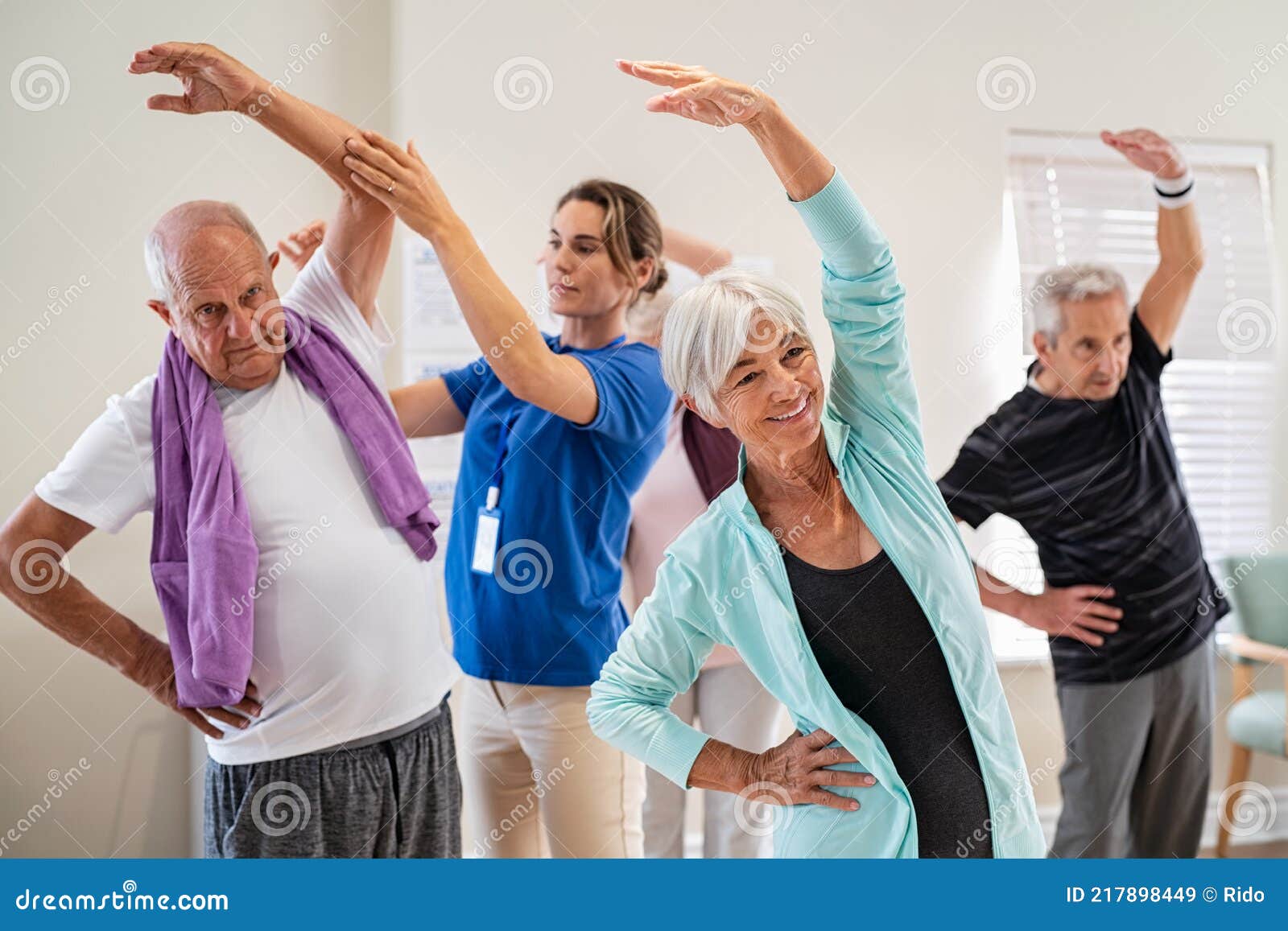 senior people stretching with trainer at retirement community