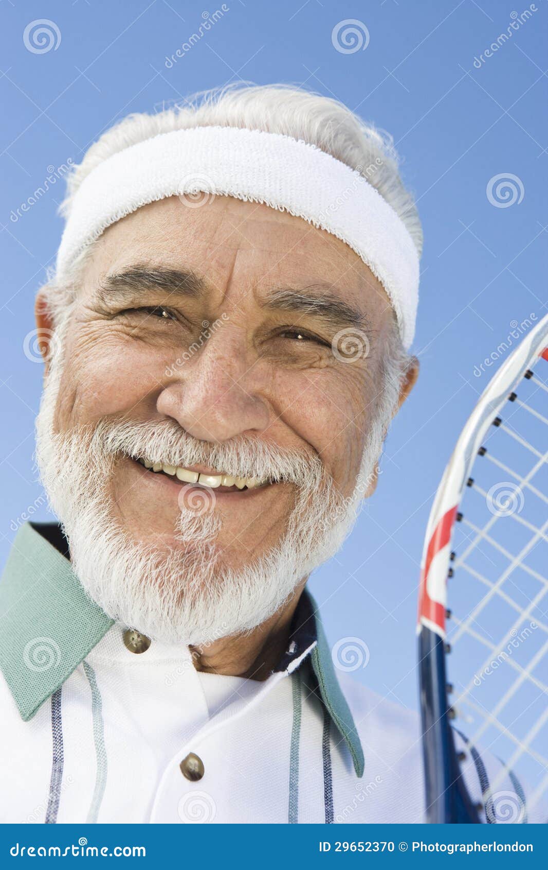 Beautiful Female Tennis Player Wearing A Headband Holding Her