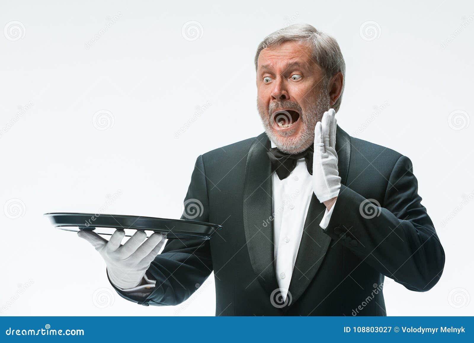 senior waiter holding tray