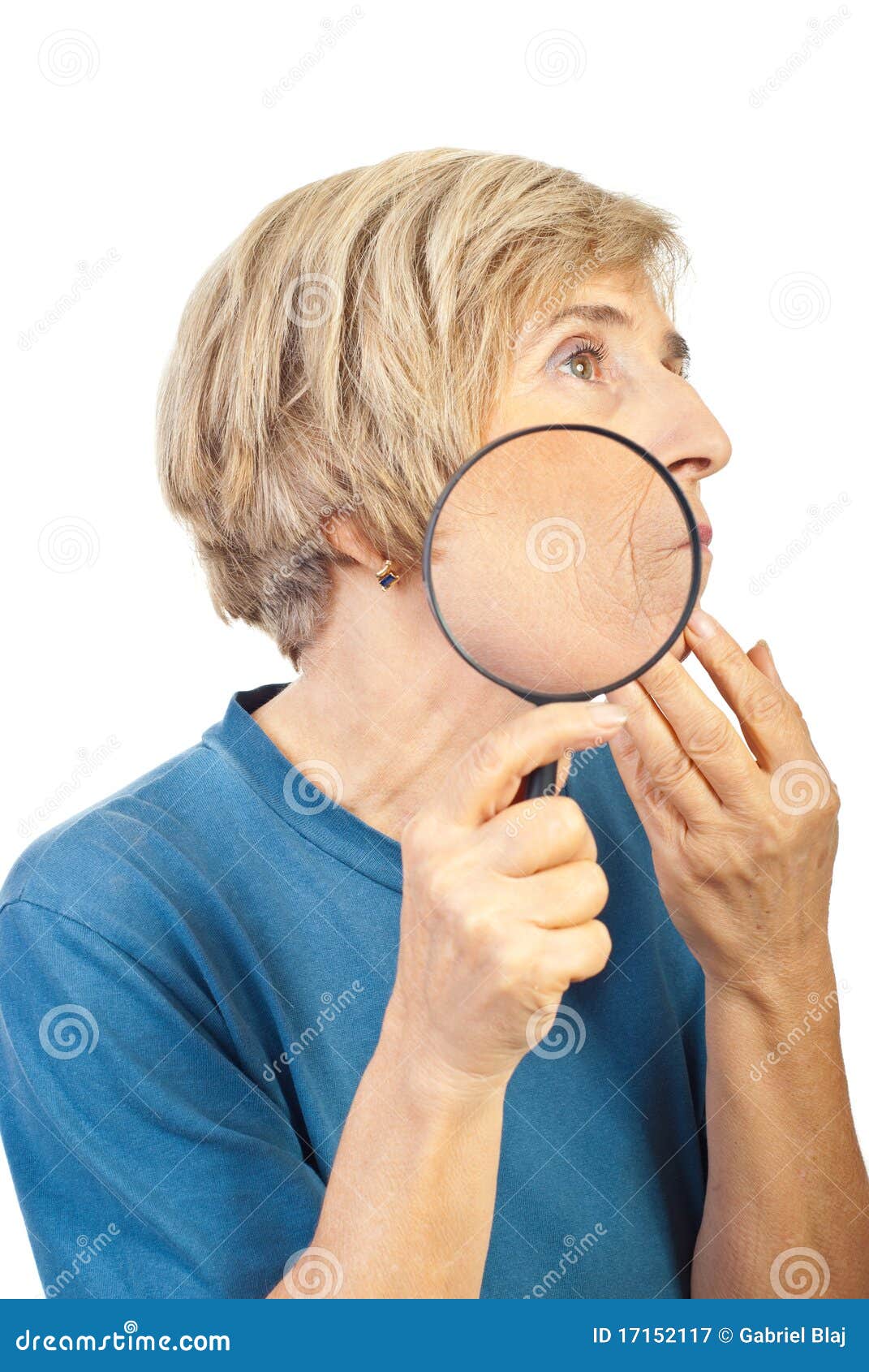 senior woman analyze her wrinkles with loupe