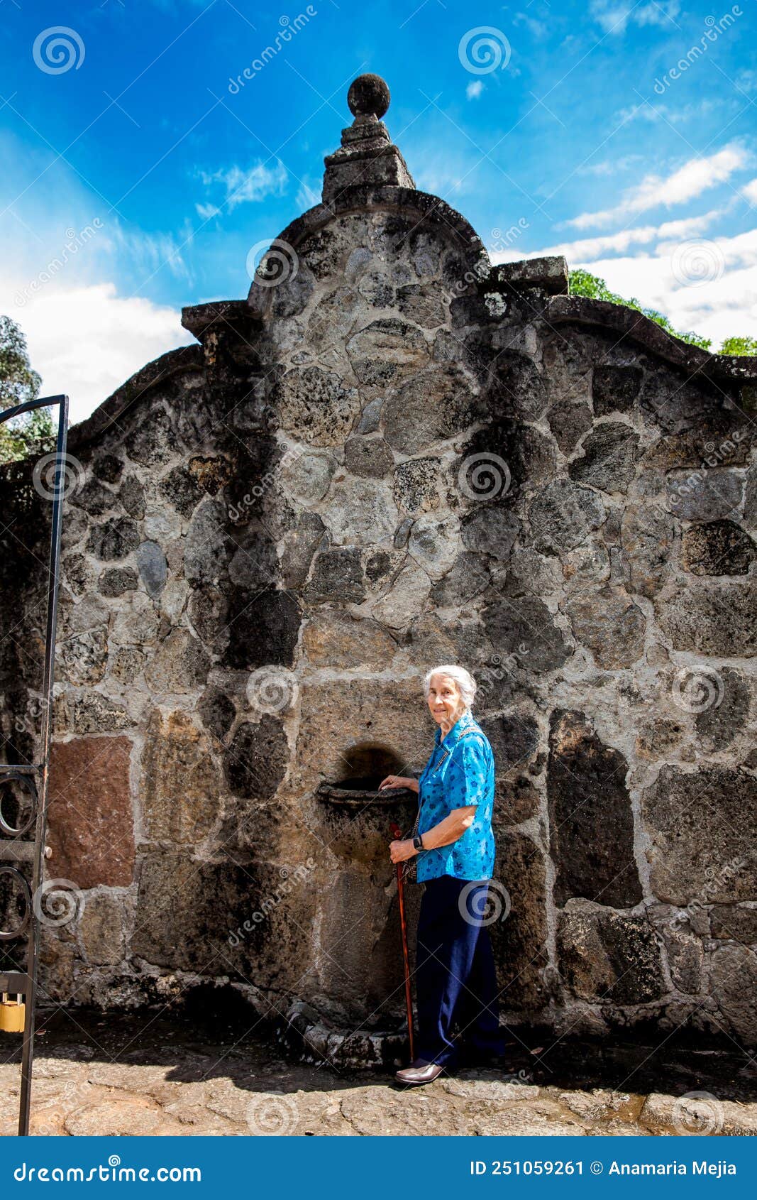 senior woman at the beautiful historical church la ermita built in the sixteenth century in the town of mariquita in colombia
