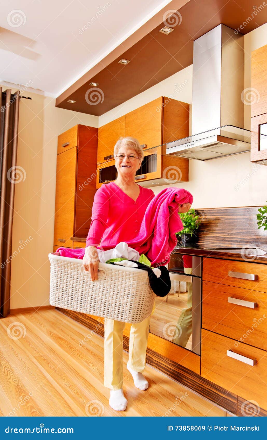 Senior Woman Carrying Laundry Basket in Kitchen Stock Image Image of clothes, load 73858069