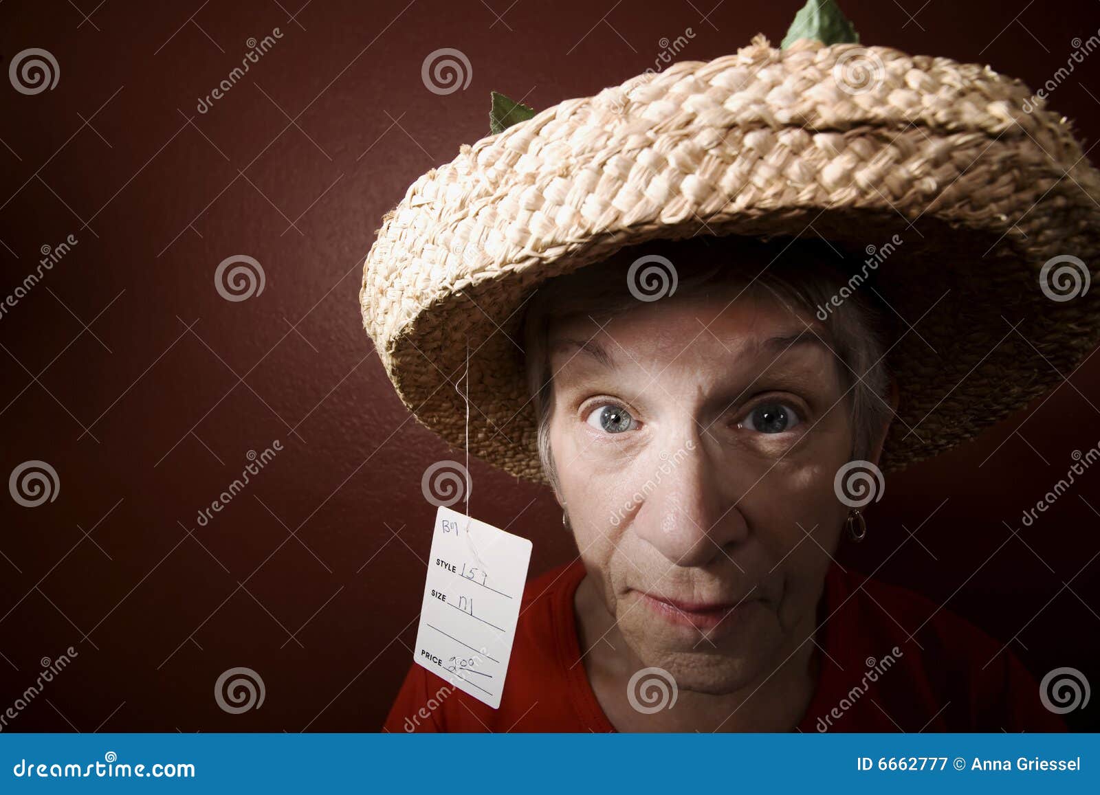 senior woman in a cheap straw hat