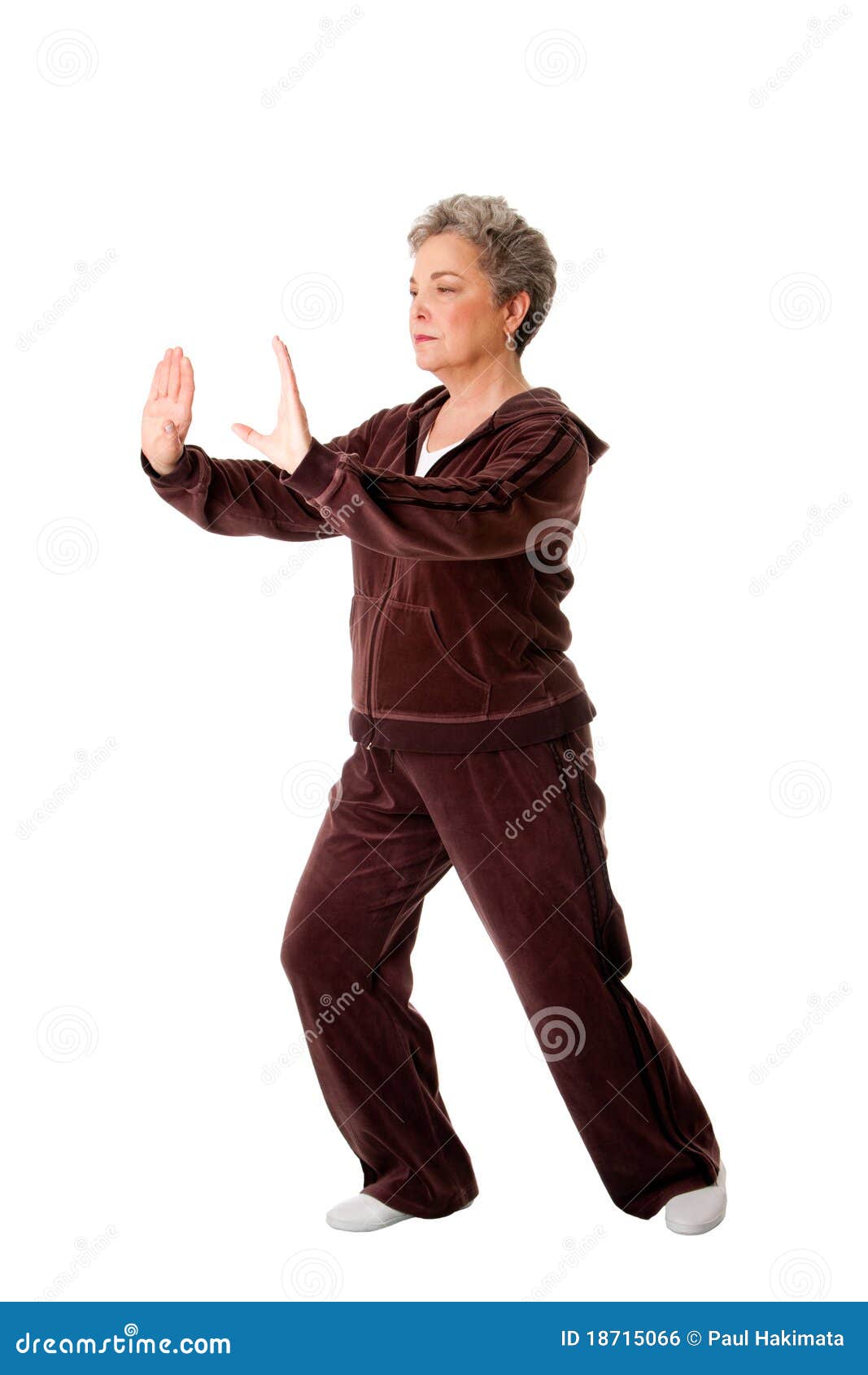 senior woman doing tai chi yoga exercise