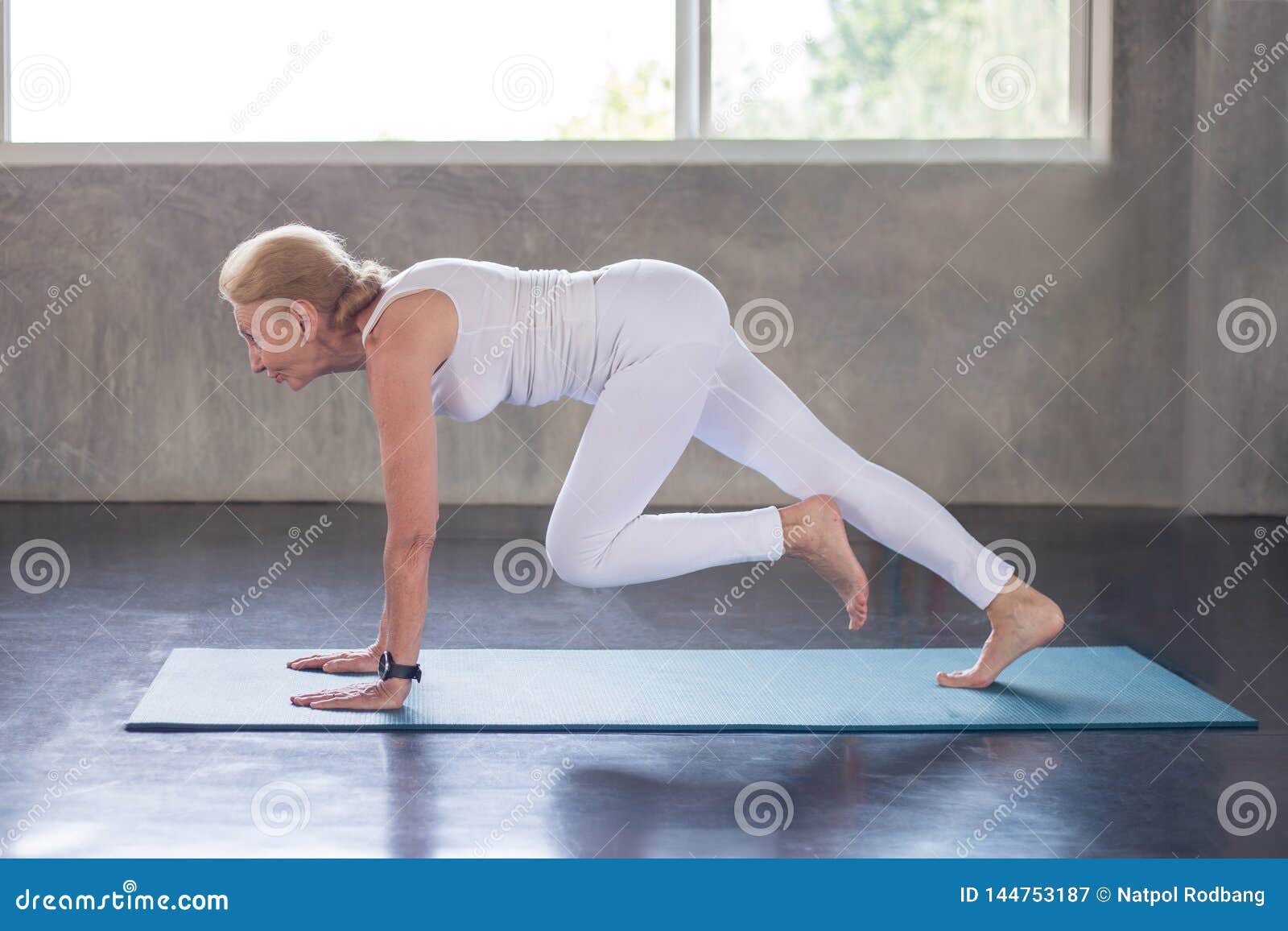 senior woman doing yoga in fitness gym. aged lady exercising.  old female workout .mature sport training.rehabilitation.elderly