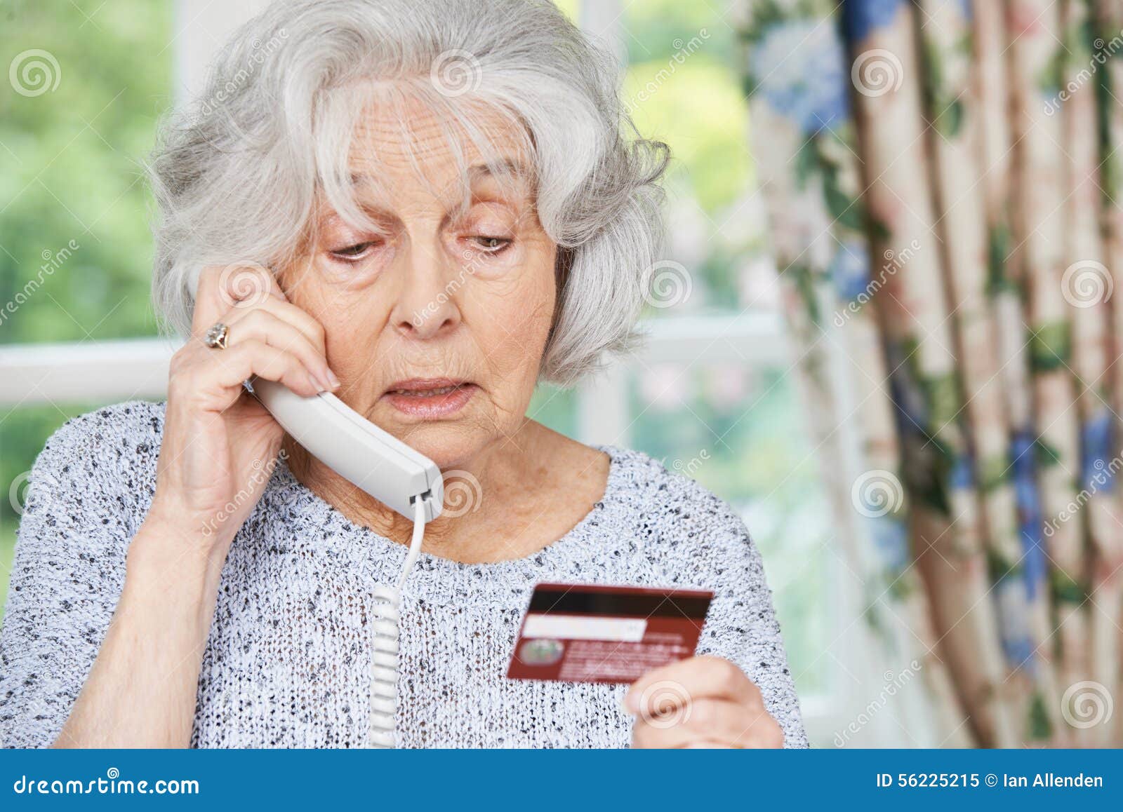 senior woman giving credit card details on the phone