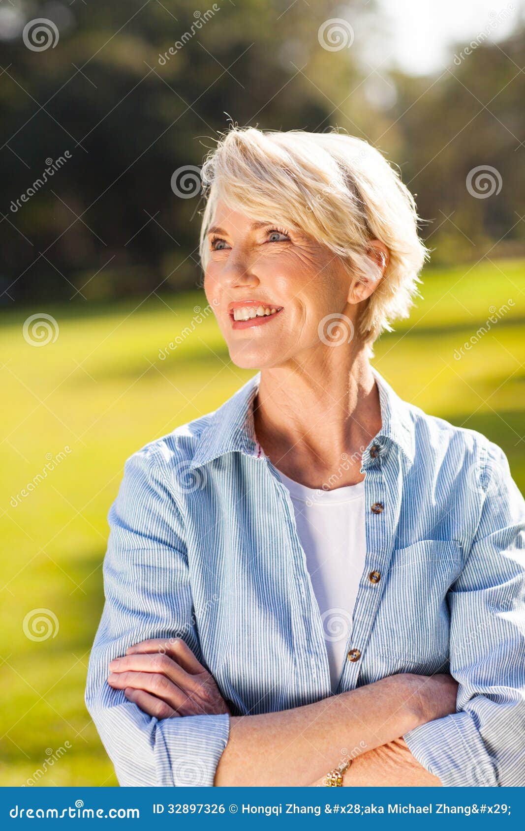 Pretty senior woman outdoors looking away