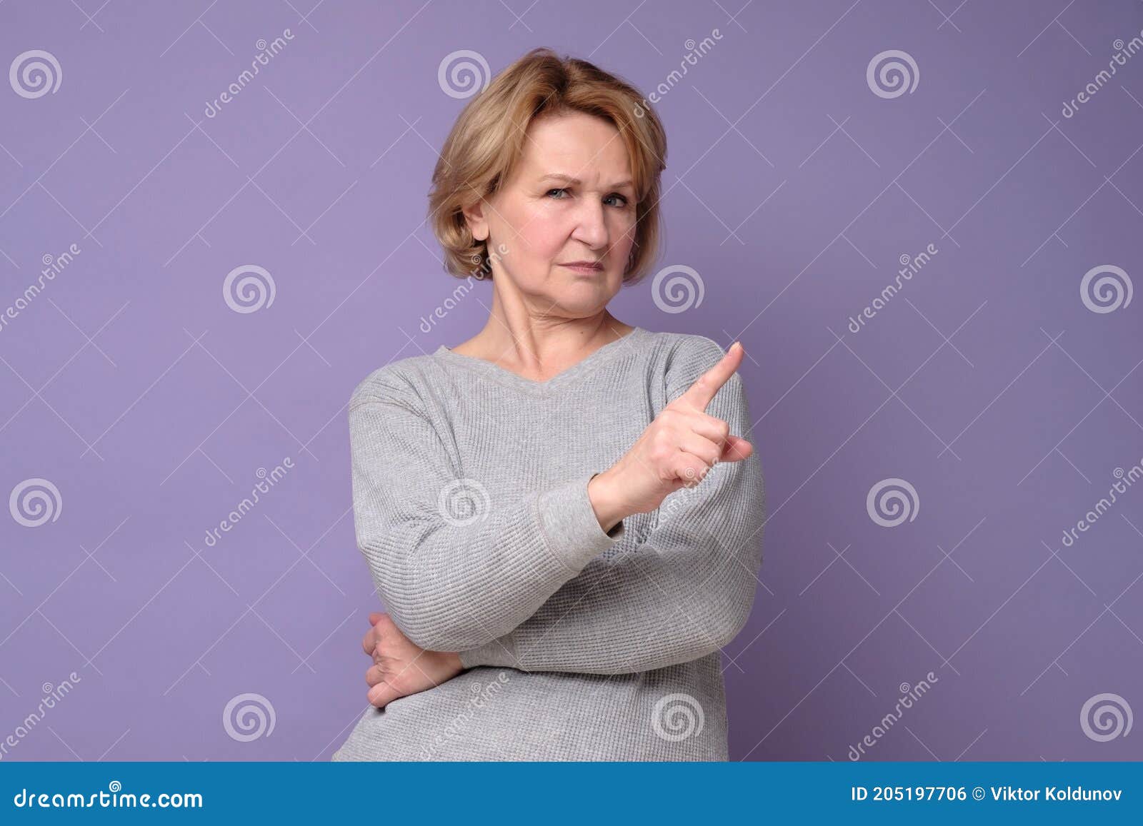 senior woman with rejection expression doing negative sign saying no.