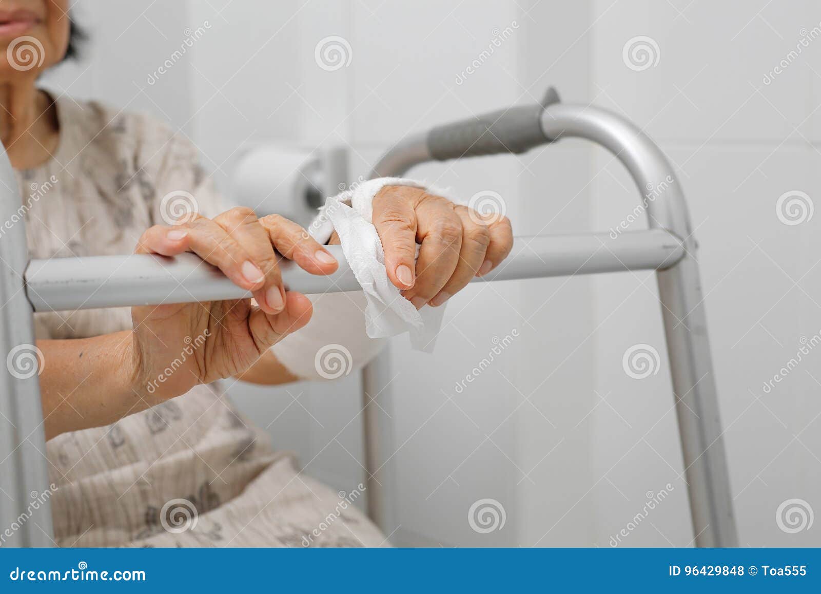 Senior Woman Using the Toilet with Walker. Stock Photo Image of