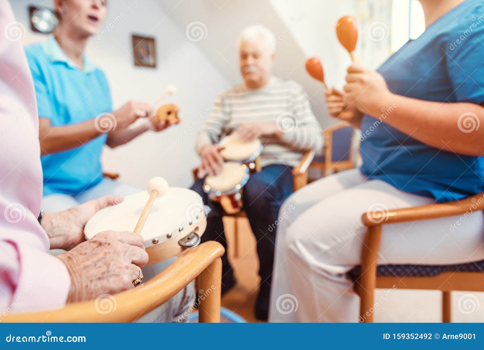 seniors in nursing home making music with rhythm instruments