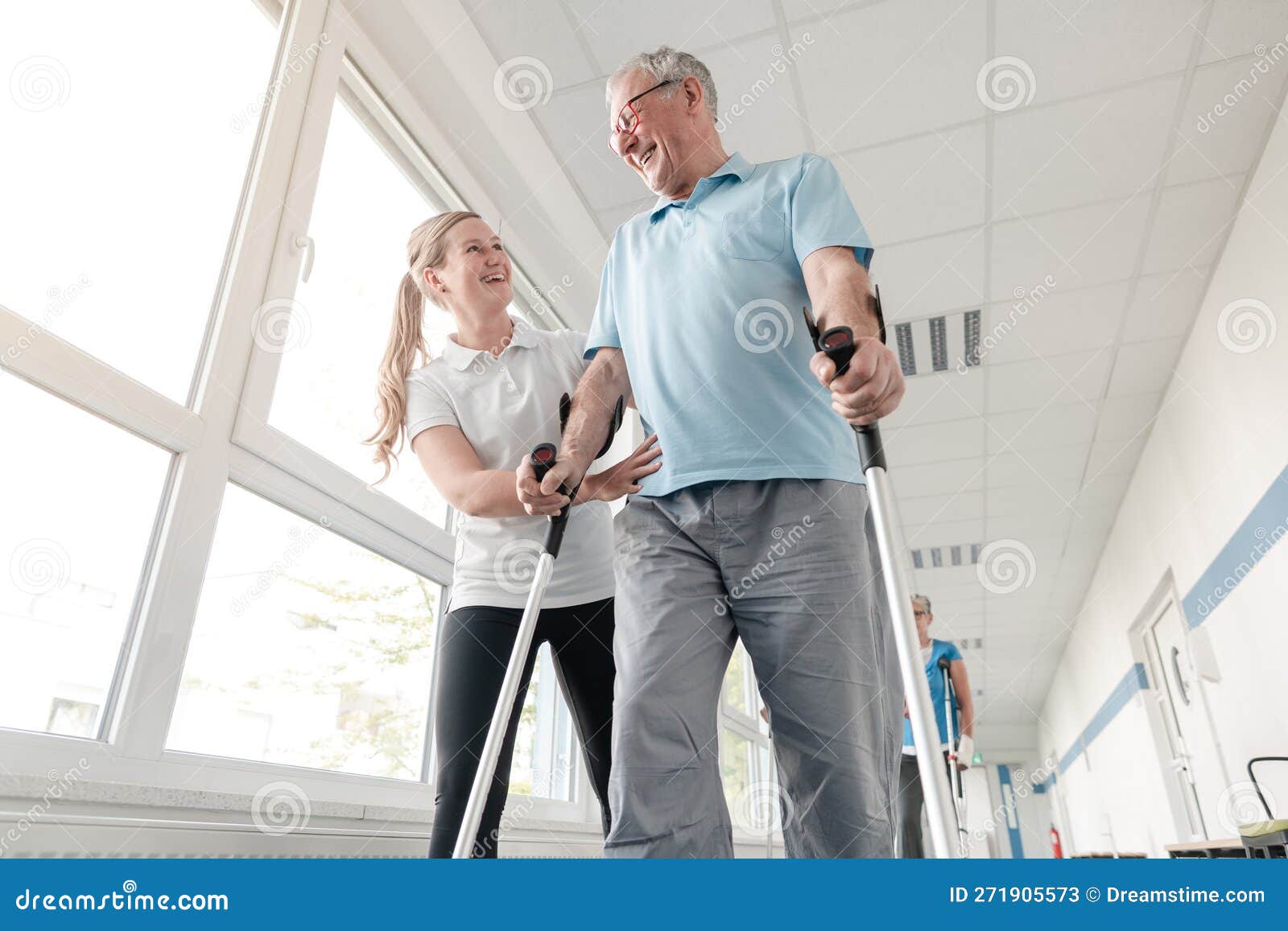 seniors in rehabilitation learning how to walk with crutches