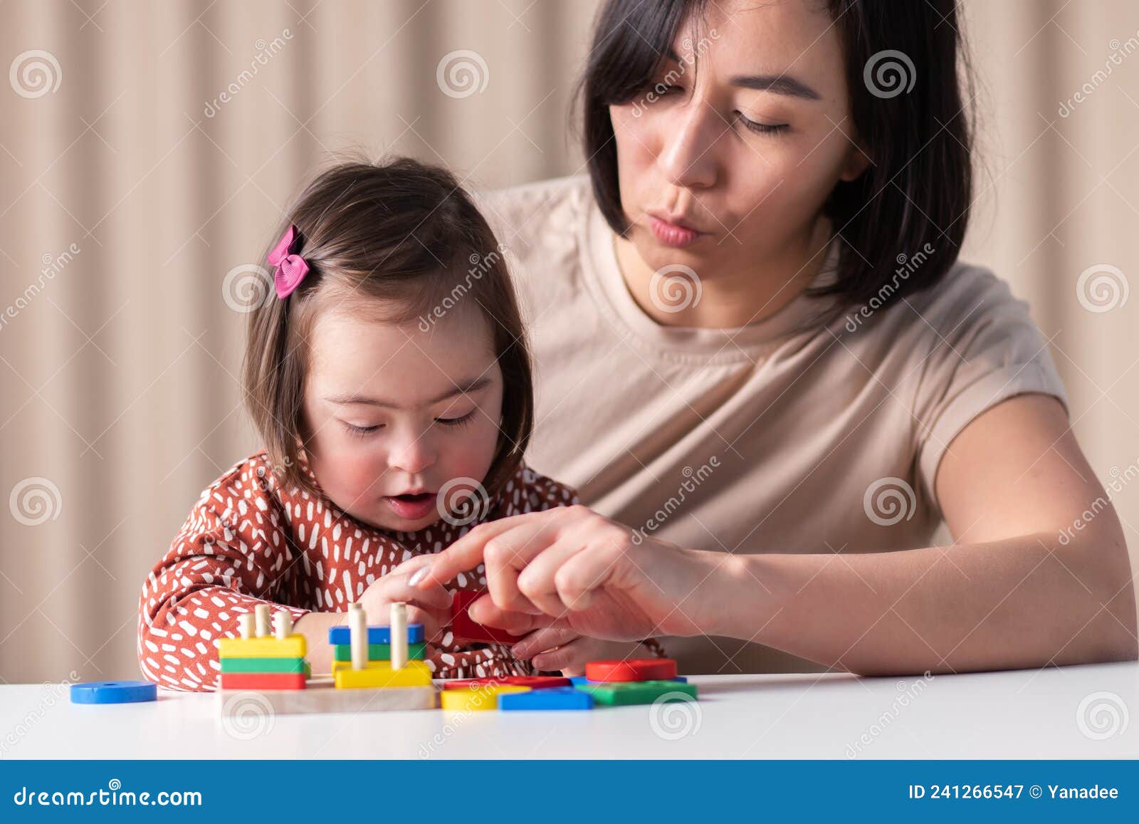 sensorimotor development of children with down syndrome,cute girl with her mother
