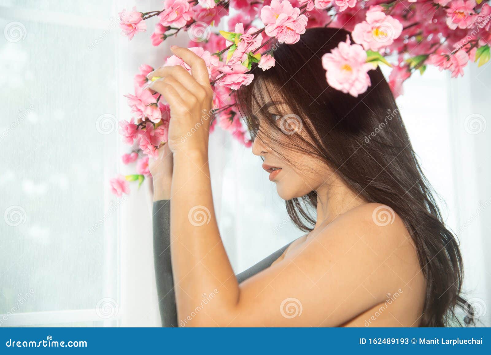 Sensual Asian Women Sensuality Standing Under Pink Flower Near Window