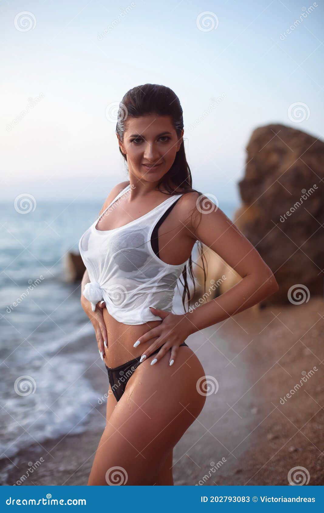 Sensual Wet Bikini Model in Sea Waves. Carefree Woman Enjoying