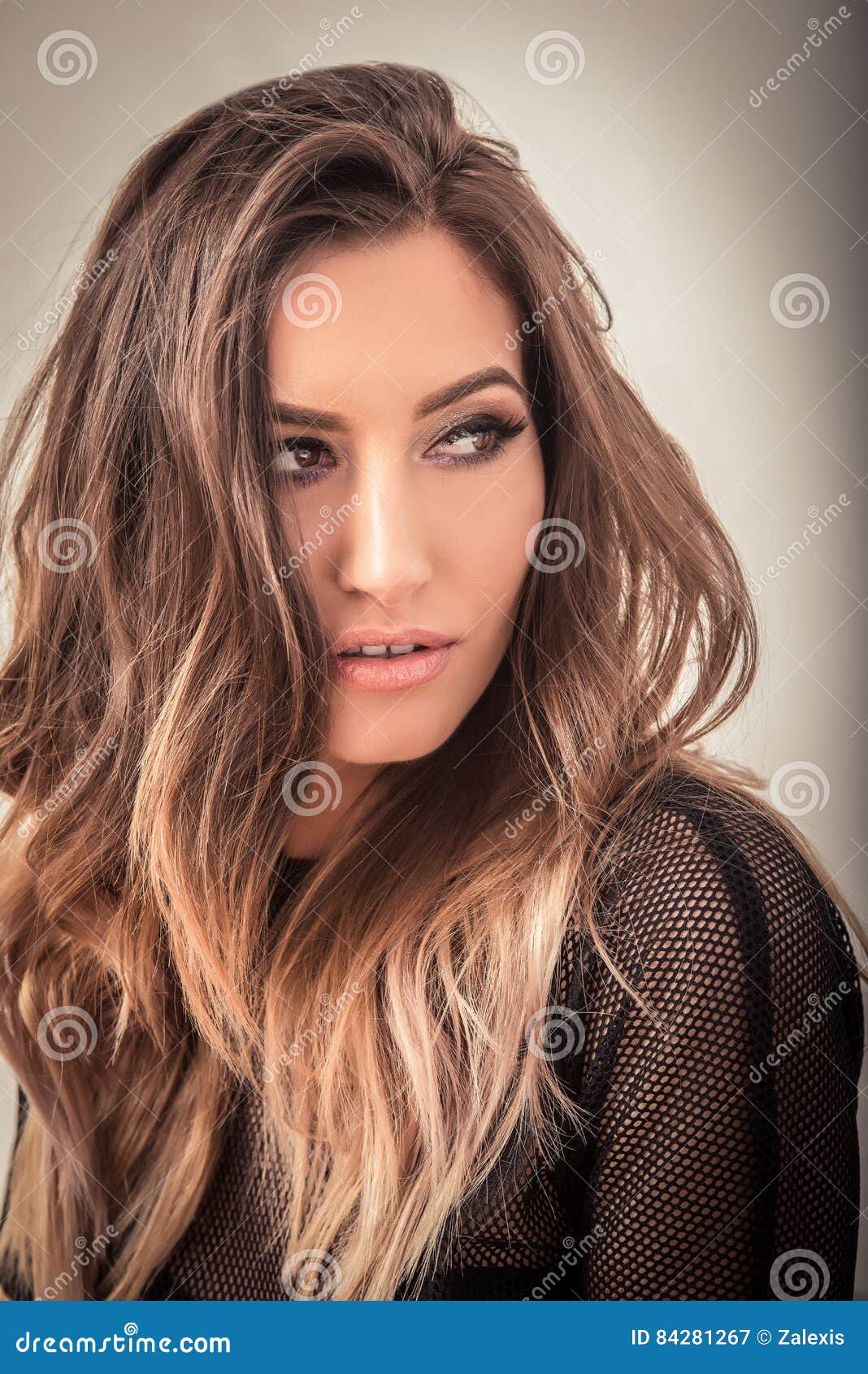 sensual woman with blonde ombre hair looking away