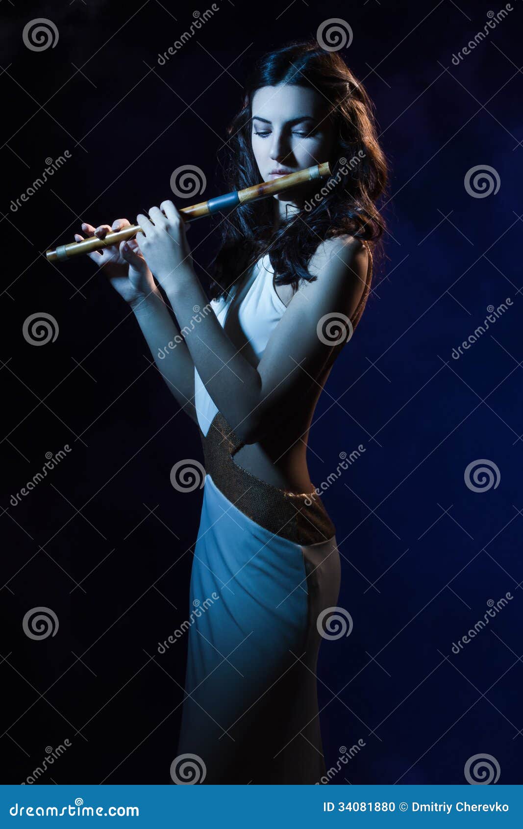 sensuality brunette plays a wooden flute