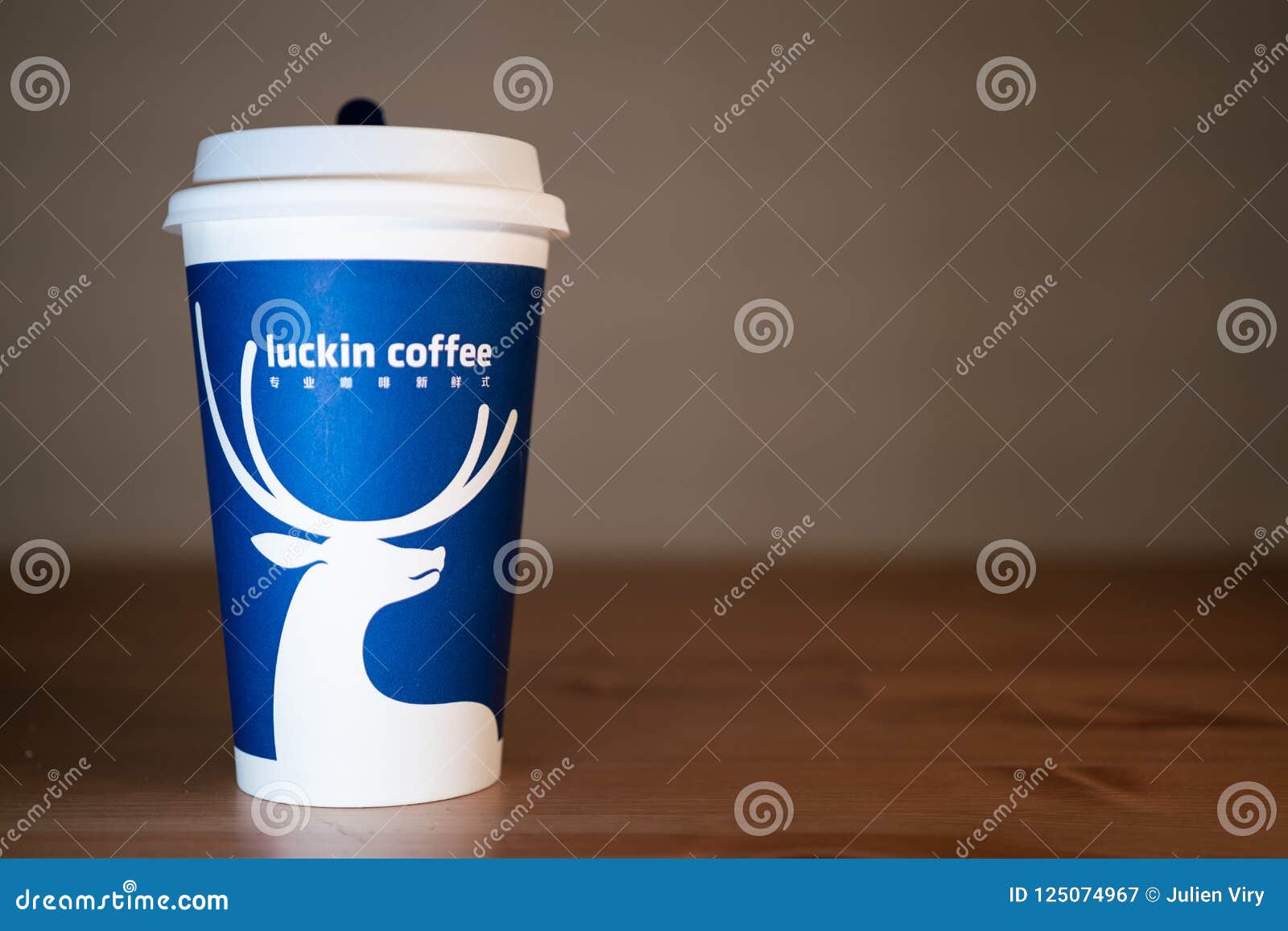 A Coffe Cup Of Luckin Coffee On Wooden Table Background