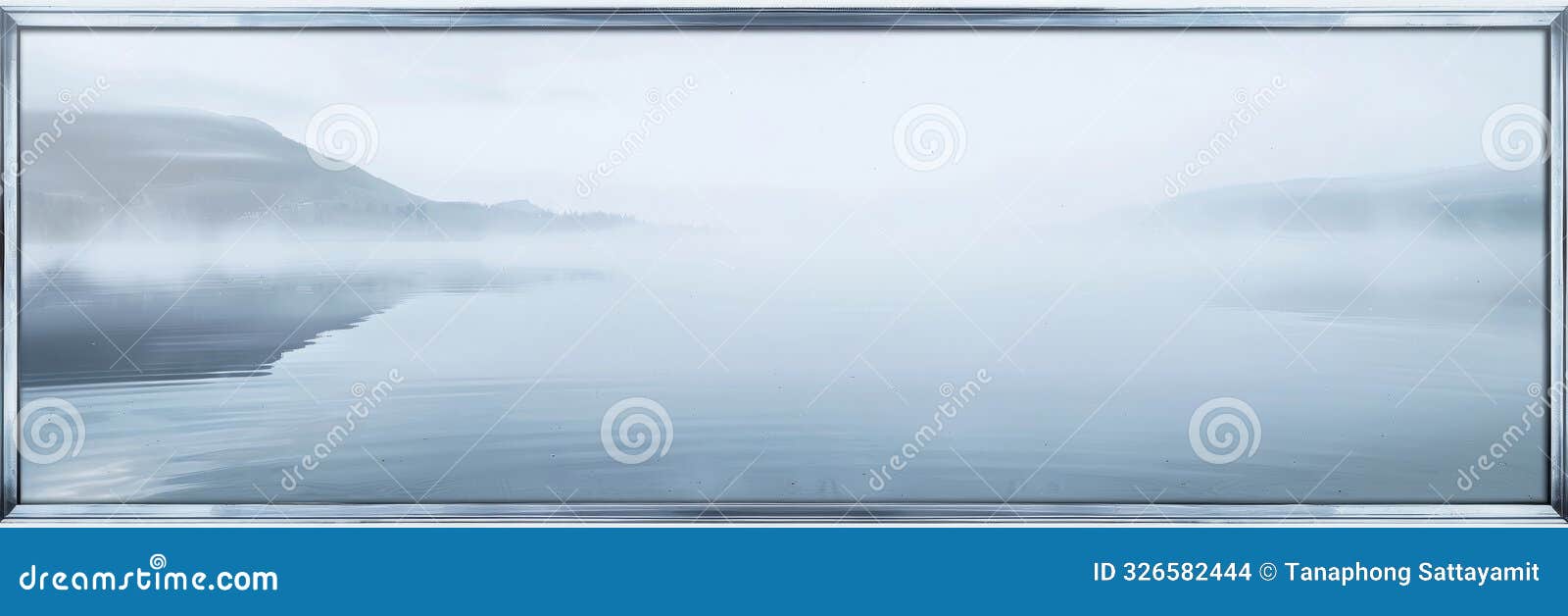 serene mirrored lake with perfectly reflective surface mirroring the clear skysurrounded by subtle ethereal mist and framed by