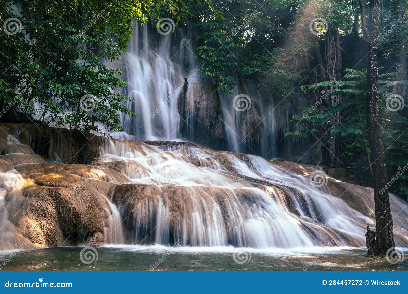 serene view of namtok sai yok noi waterfall in the kanchanaburi province of thailand.