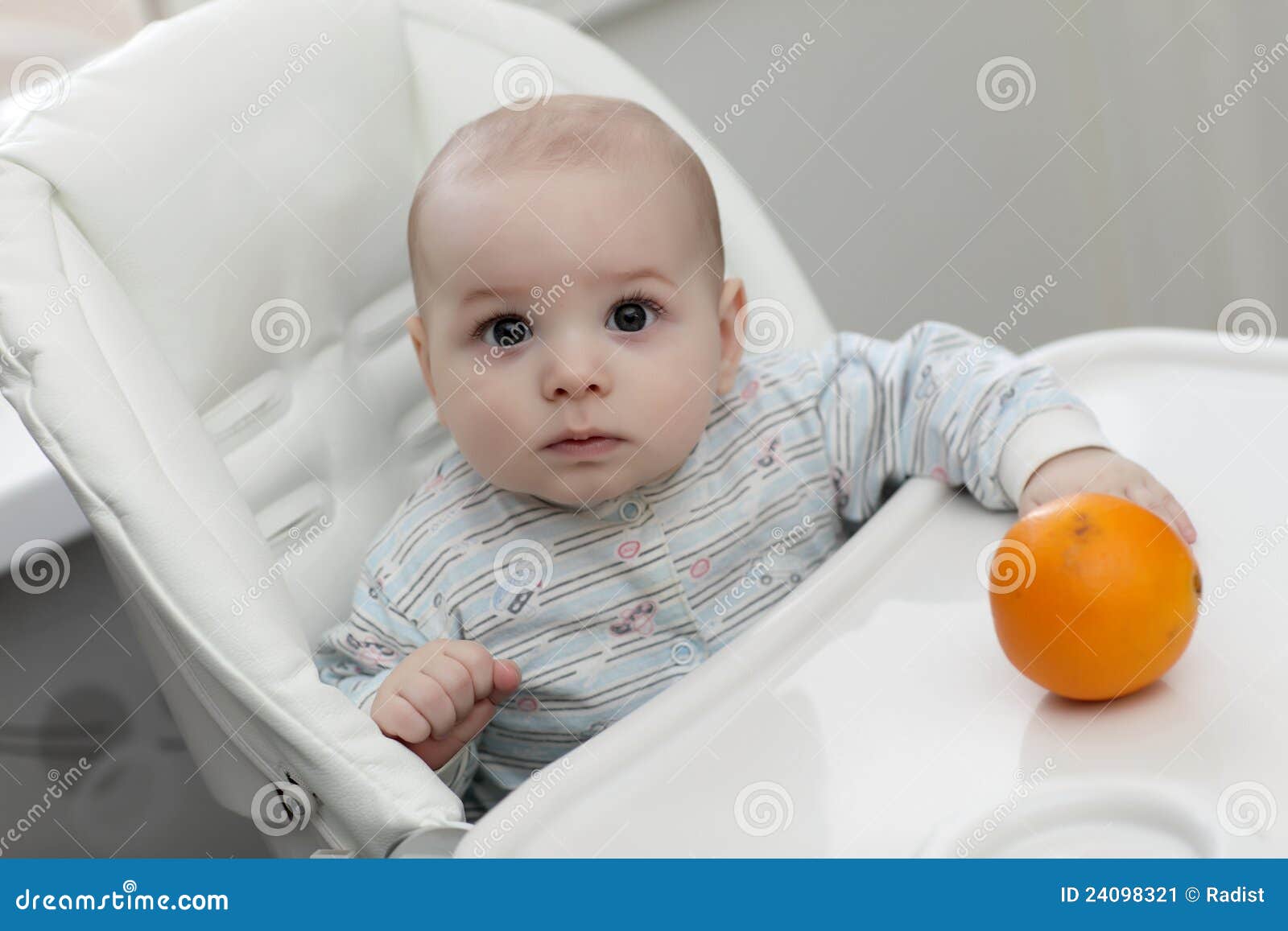 Serious baby with orange stock image. Image of fruit 24098321