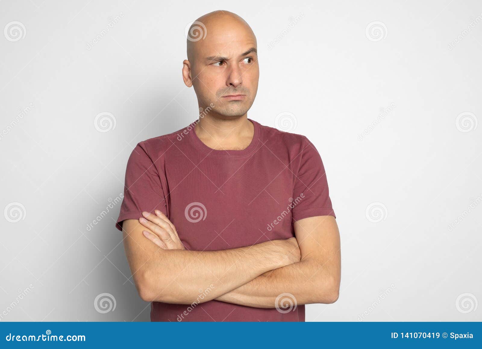 serious bald man looking aside with suspicion