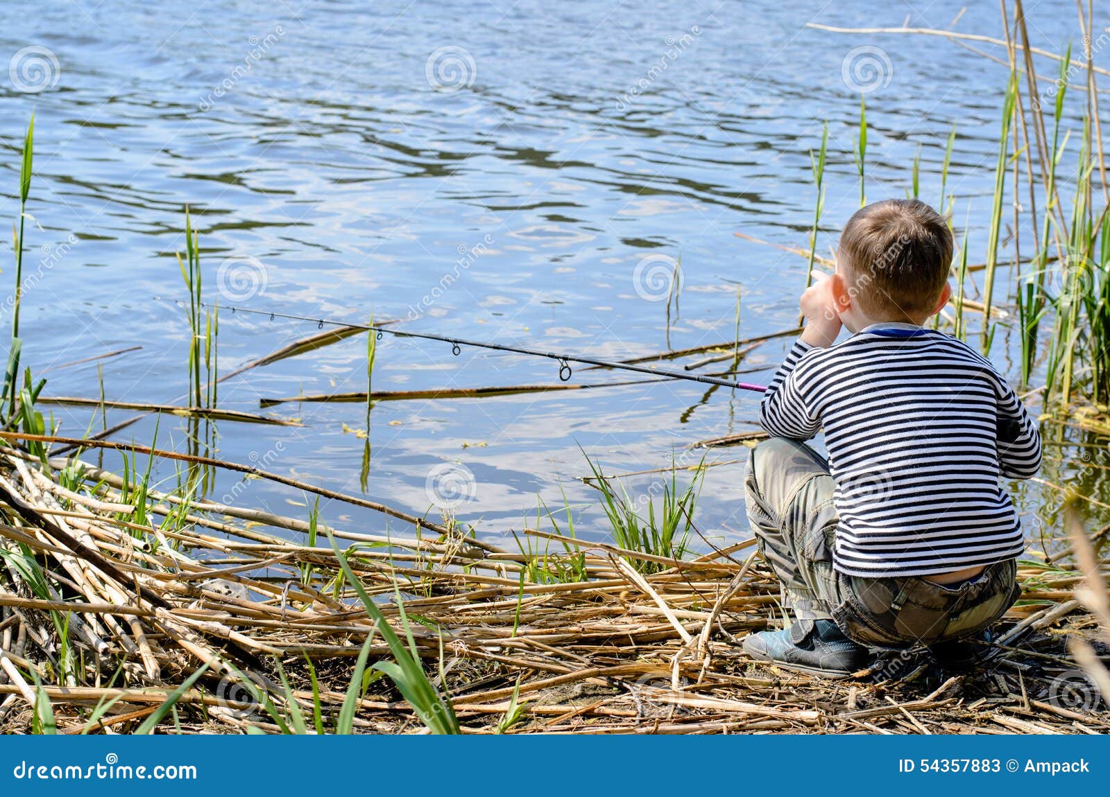 Serious Boy Sitting on Riverside while Fishing Stock Image - Image