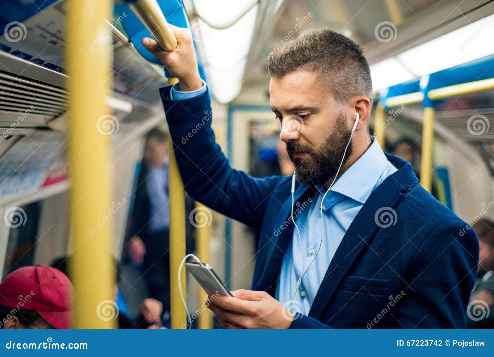 serious businessman travelling to work. standing inside underground wagon.