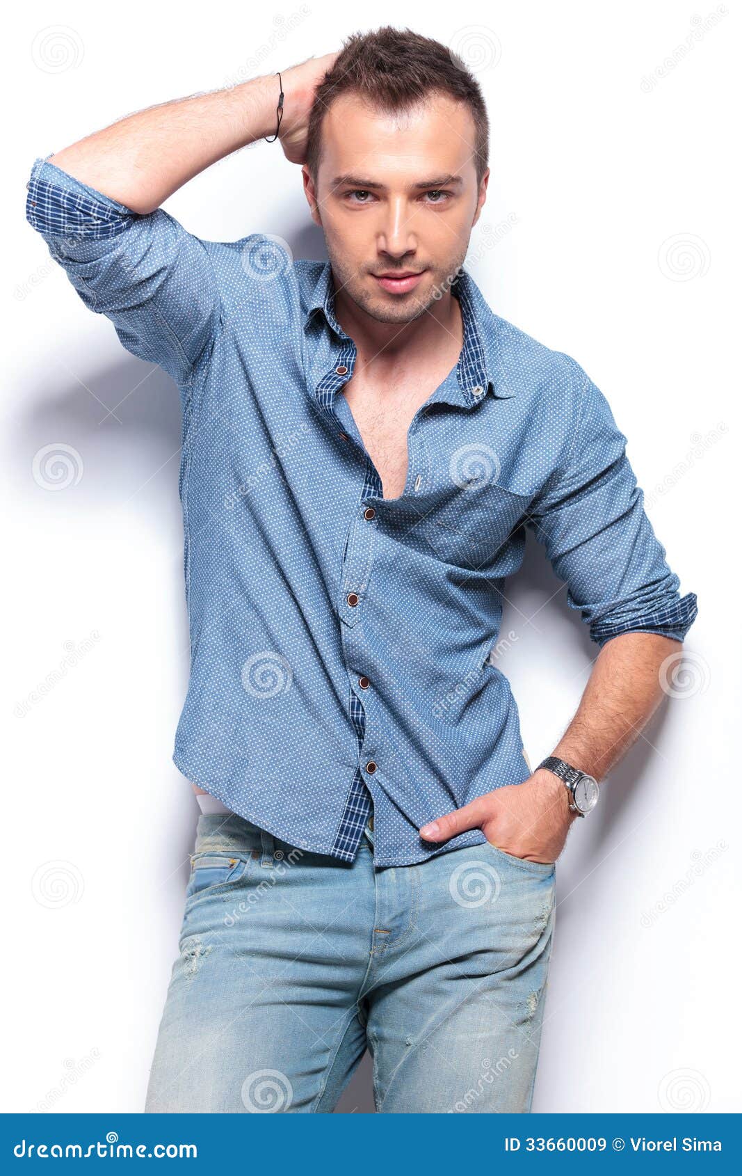 Serious Casual Man Poses With Hand On Head And In Pocket Royalty Free