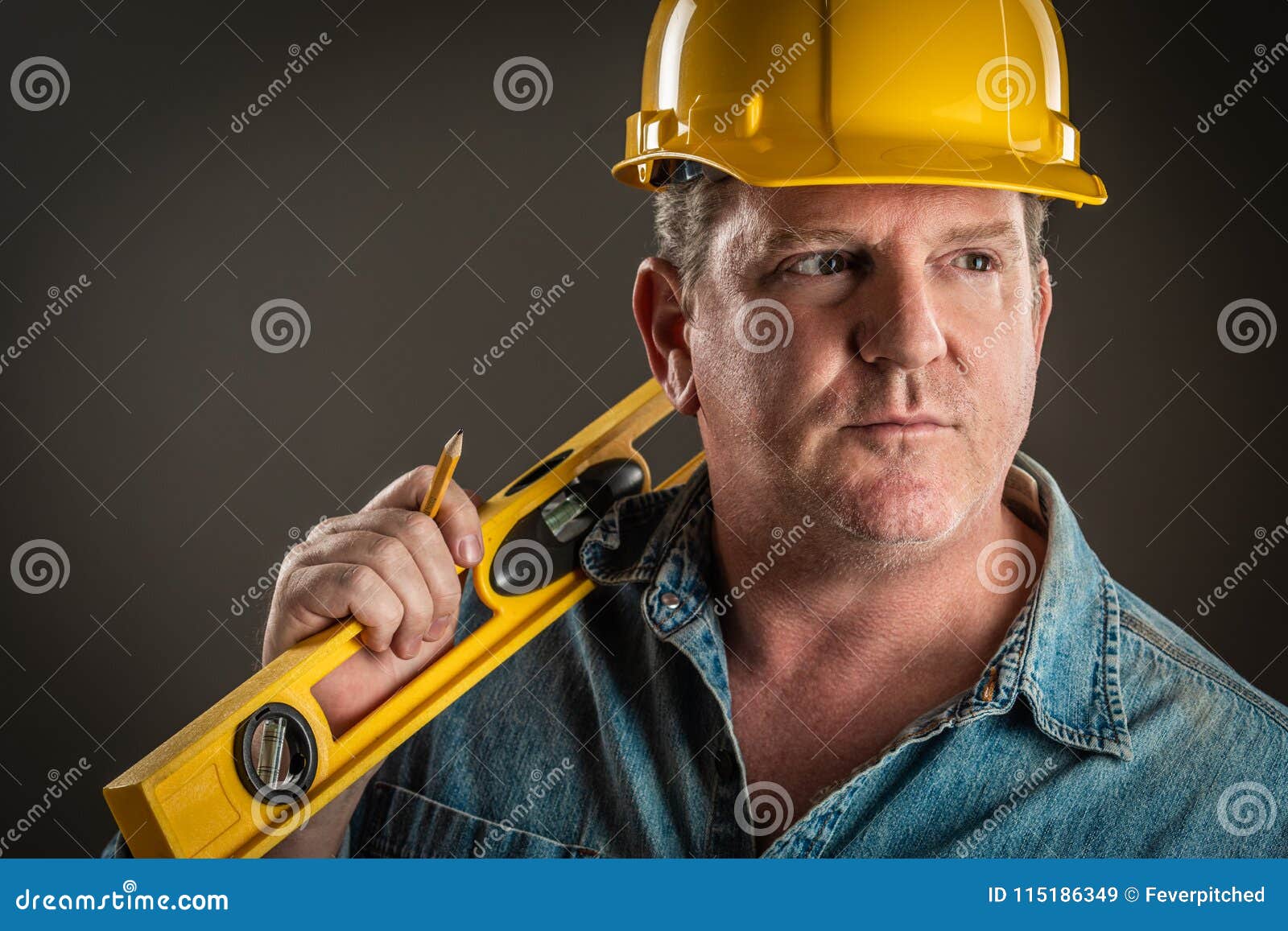 Serious Contractor in Hard Hat Holding Level and Pencil Stock Image Image of intense, helmet