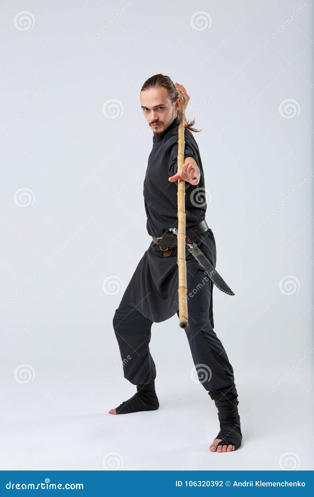 A Man with Long Hair, in a Special Black Kimono , Practicing Martial Arts  Technique with a Bamboo Stick. Stock Photo - Image of dark, clothing:  106320392