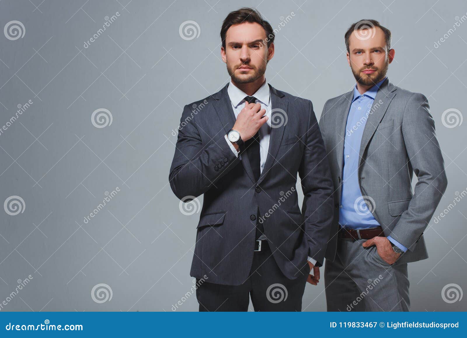 Serious Handsome Businessman Fixing Tie Stock Image - Image of fixing ...