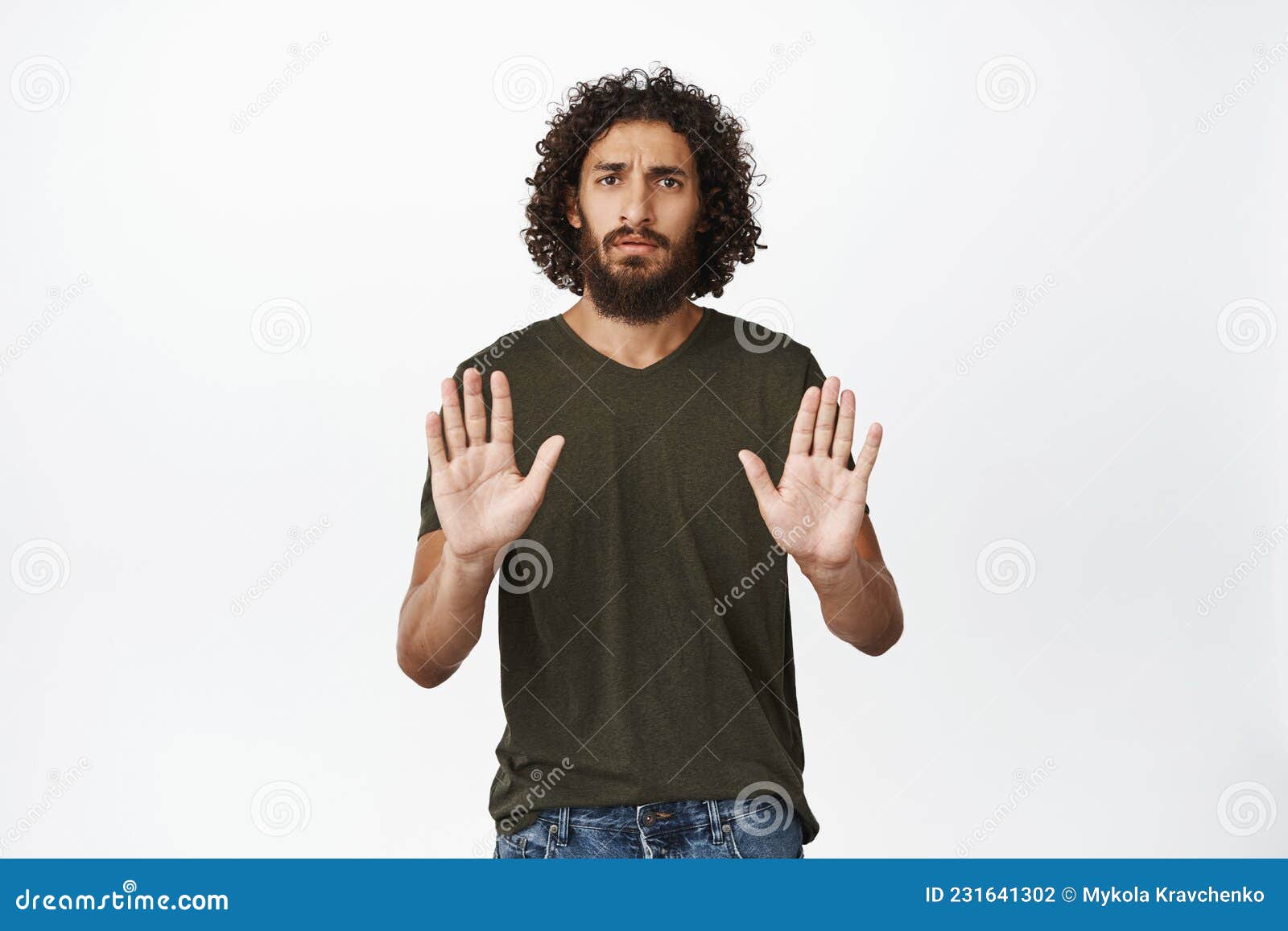 serious looking man stretching out hand, showing stop rejection gesture, saying no, decline something, standing over