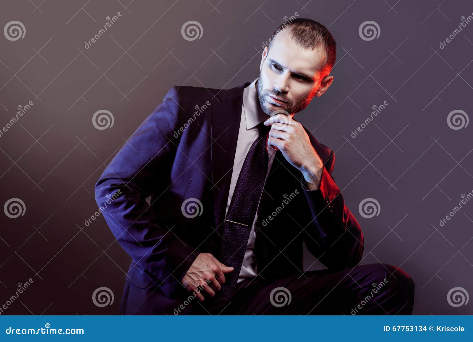 Serious Man in a Business Suit, Dark Background, Backlight Blue and Red ...