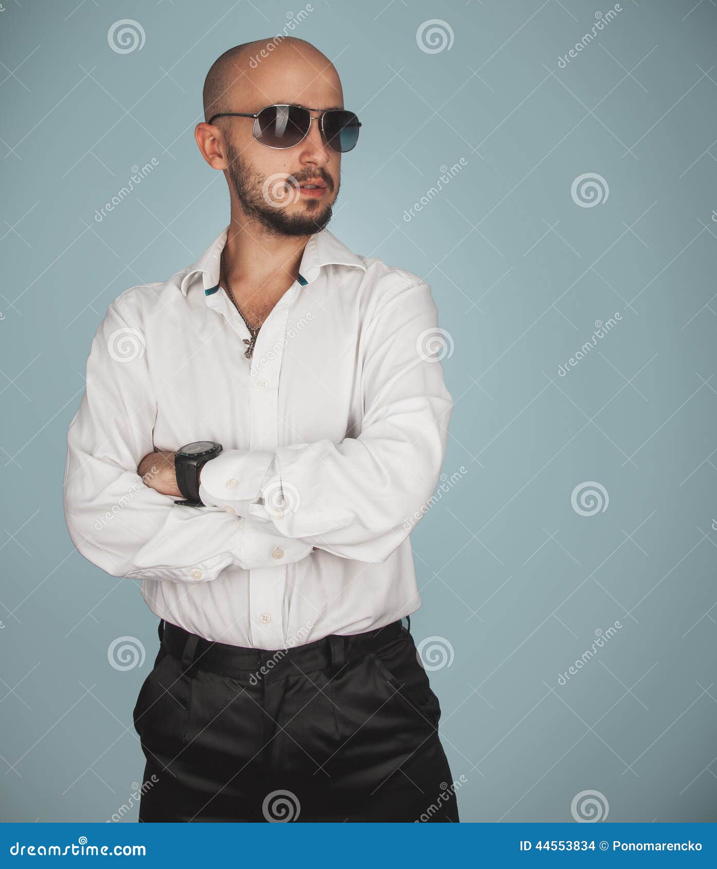 Serious man in shirt and sunglasses looking away in studio