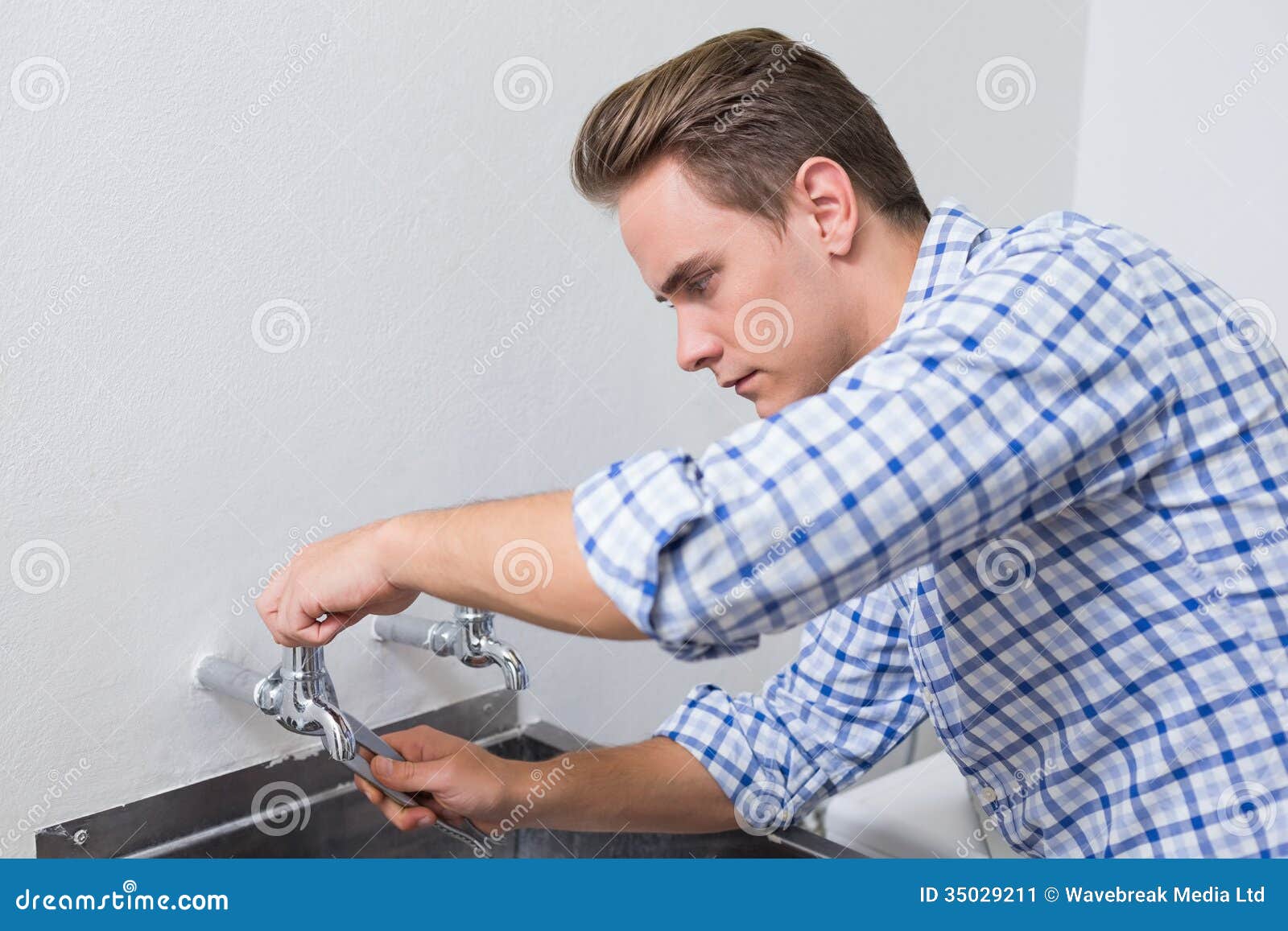 Serious Plumber Fixing Water Tap with Pliers Stock Image Image of side, profes 35029211