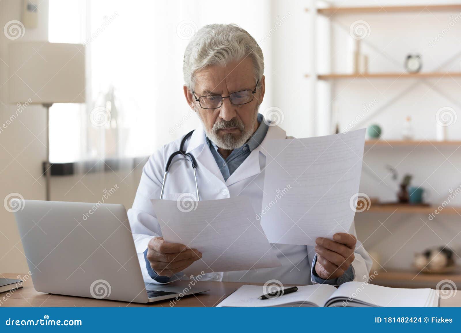 Serious Professional Senior Doctor Checking Medical Documents at ...