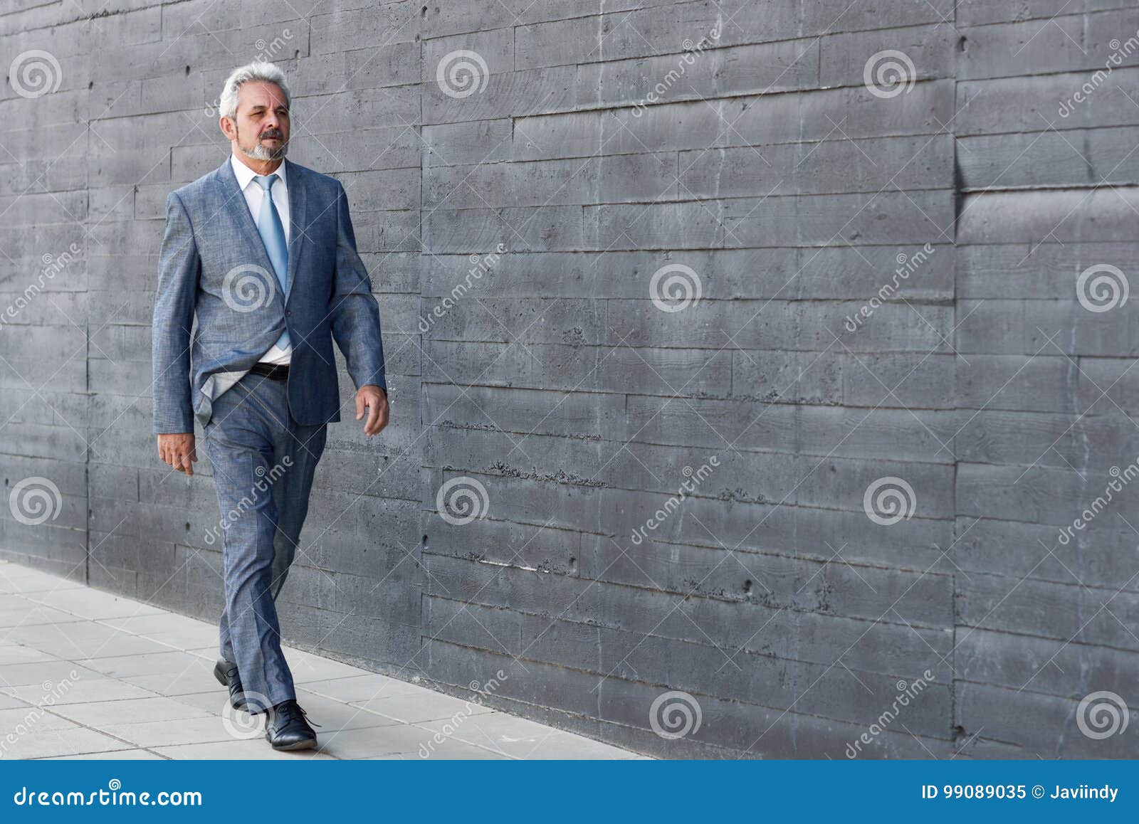 Serious Senior Businessman Walking Outside of Modern Office Building ...