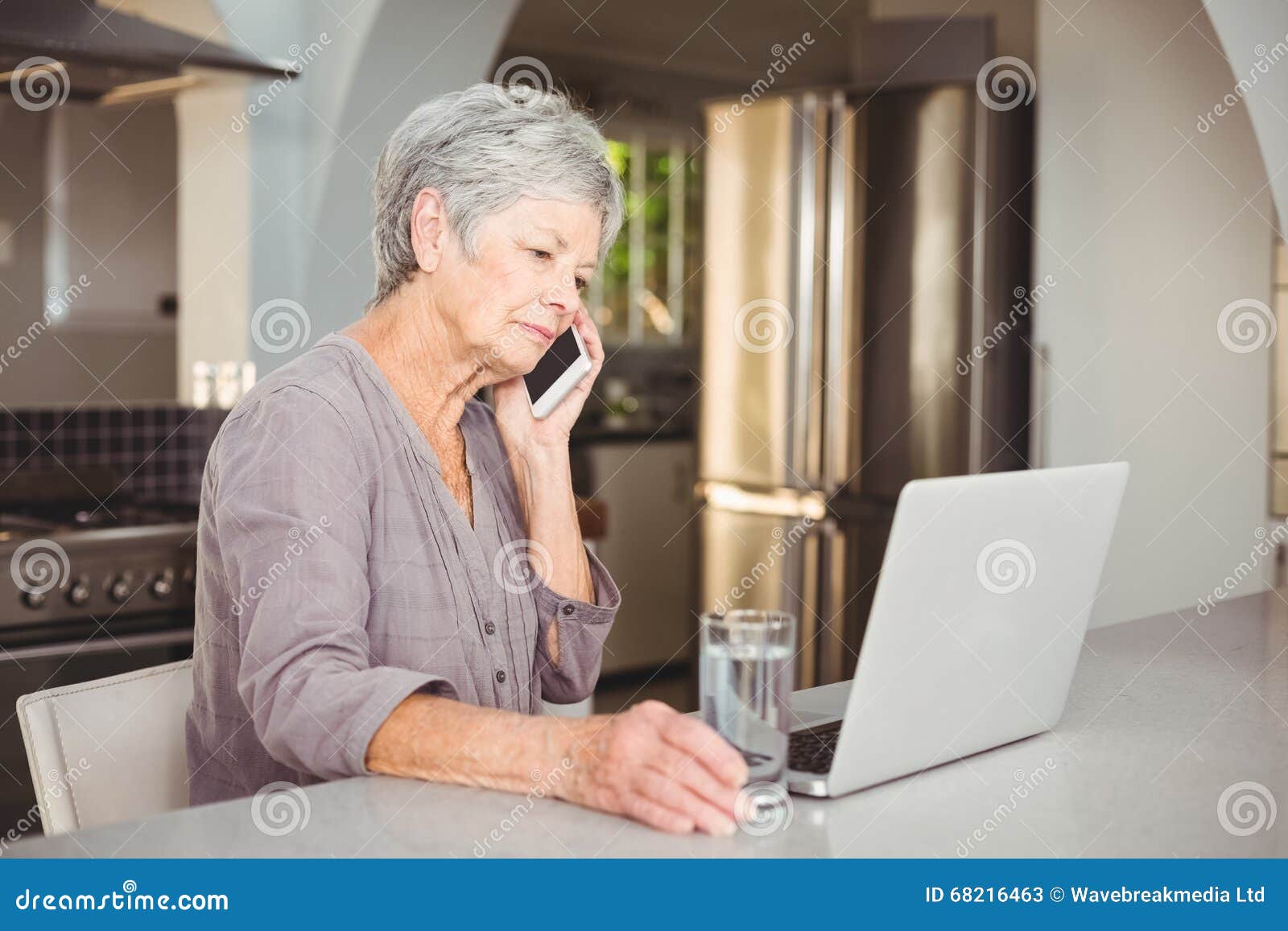 serious senior woman talking on mobile phone