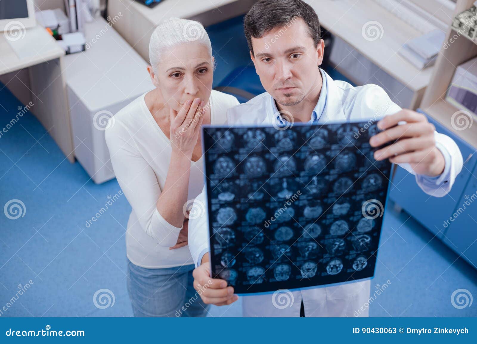 serious shocked woman looking at her brain x ray images