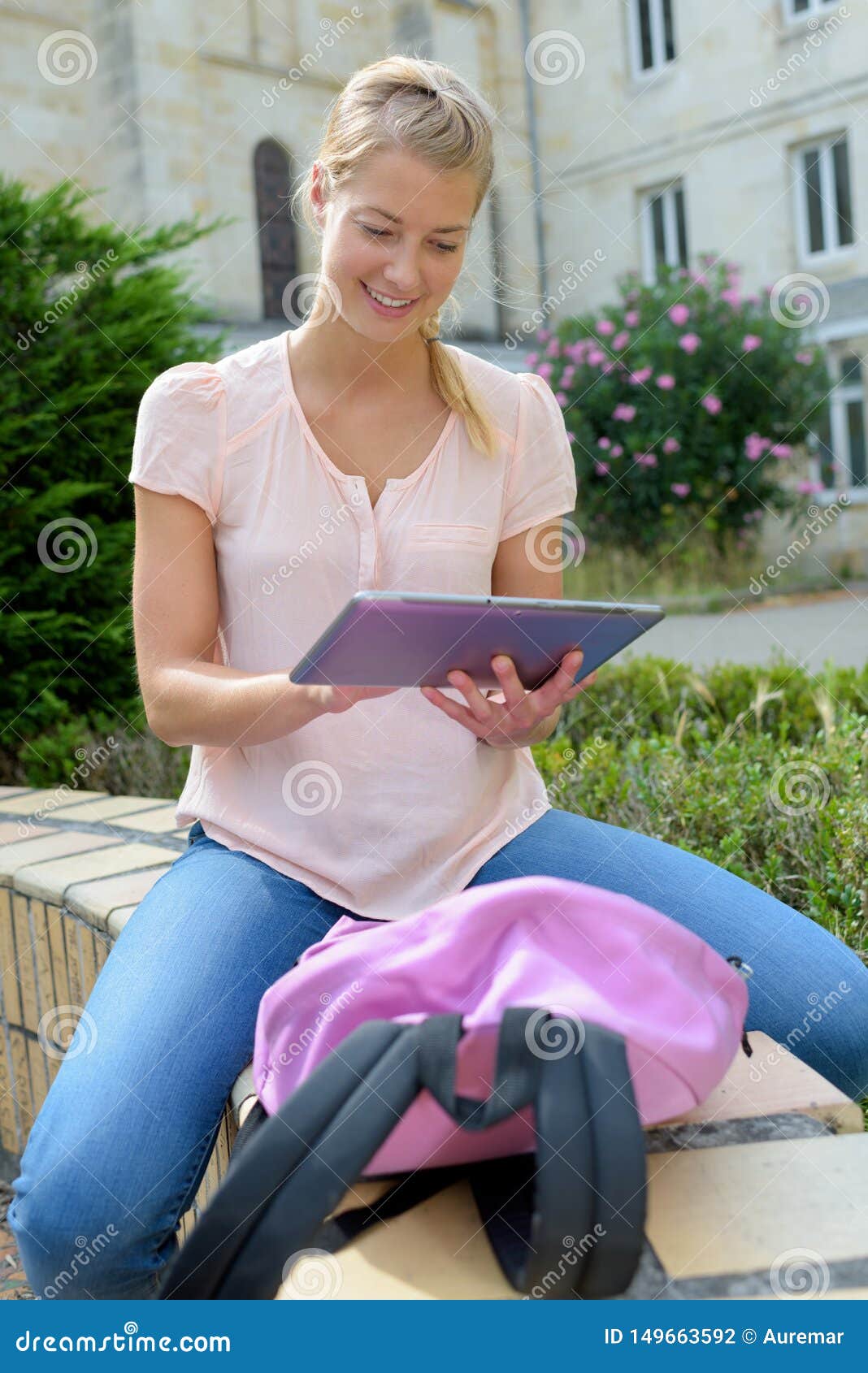 serious student girl using tablet outdoors