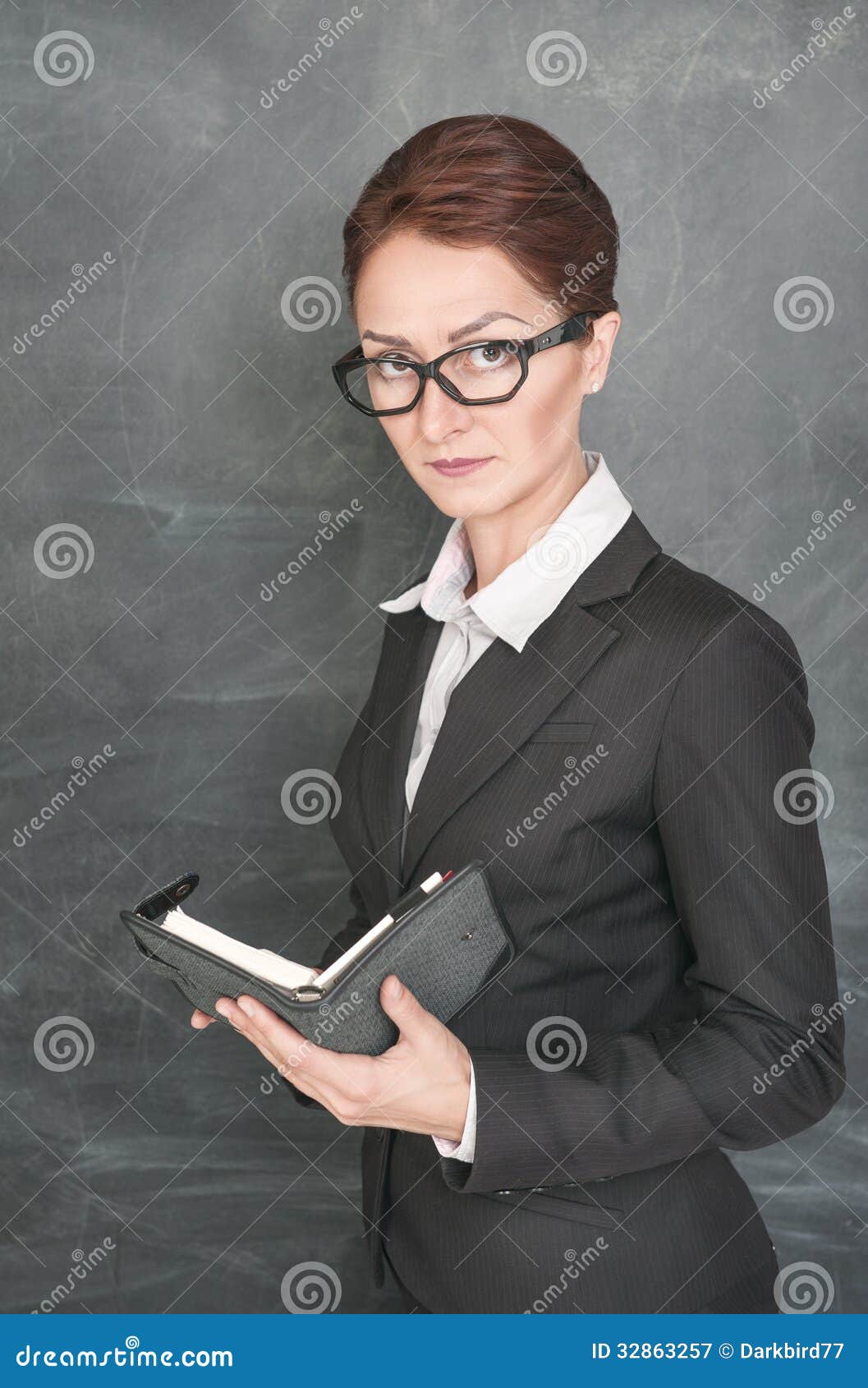 Serious Teacher Sitting In Armchair RoyaltyFree Stock Photography