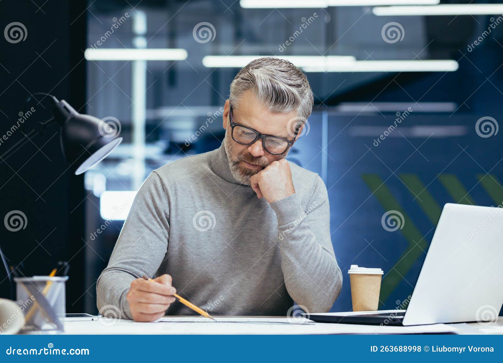 Serious Thinking Architect Designer Working on Blueprint, Mature Man