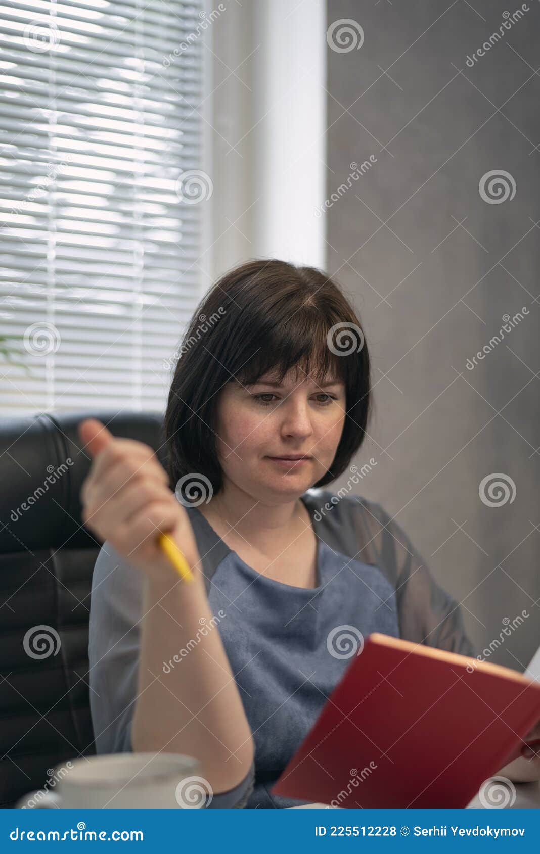 Serious Woman Chief In Her Office Reads Book And Drinks Coffee Break